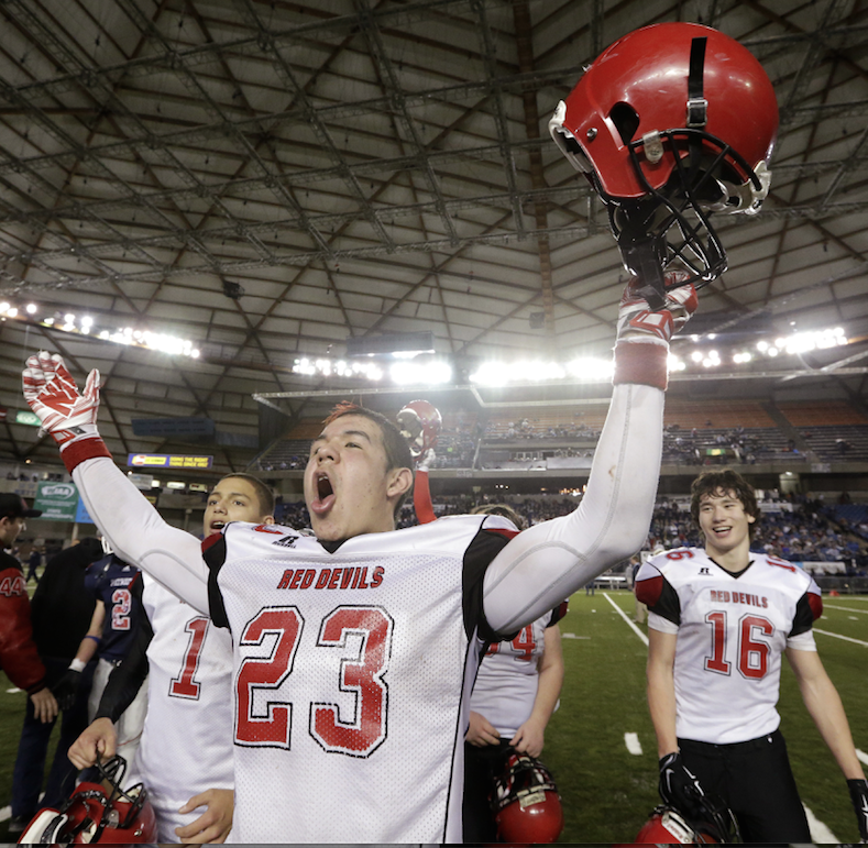 Neah Bay's Chris Martinez lets out a yell after the team beat Liberty Christian 56-38 in the state class 1B football championship game Saturday in the Tacoma Dome. The Associated Press (click on photo to enlarge)