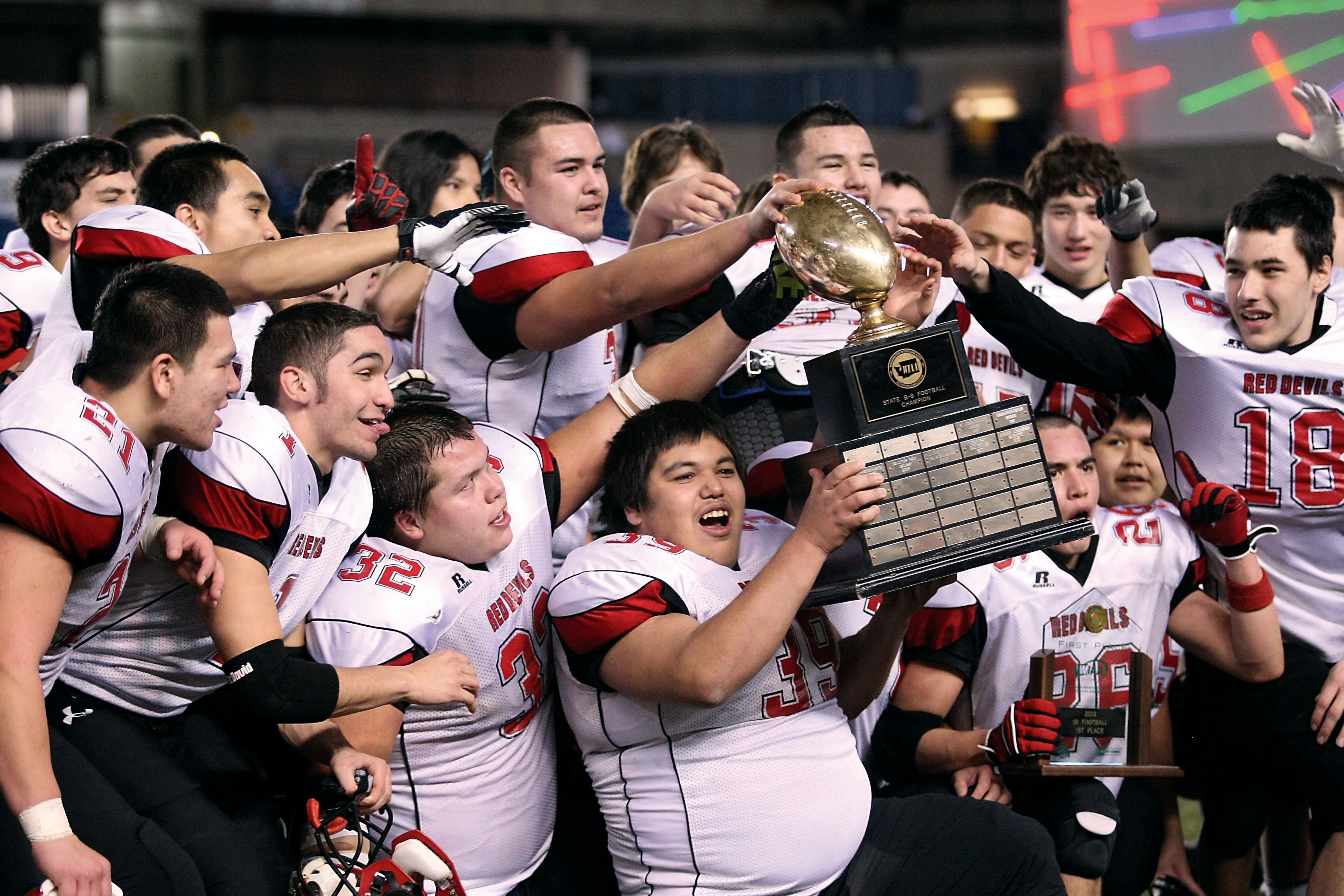 Neah Bay lineman Carl Mack (39) and teammates Mitchell McGee (21)