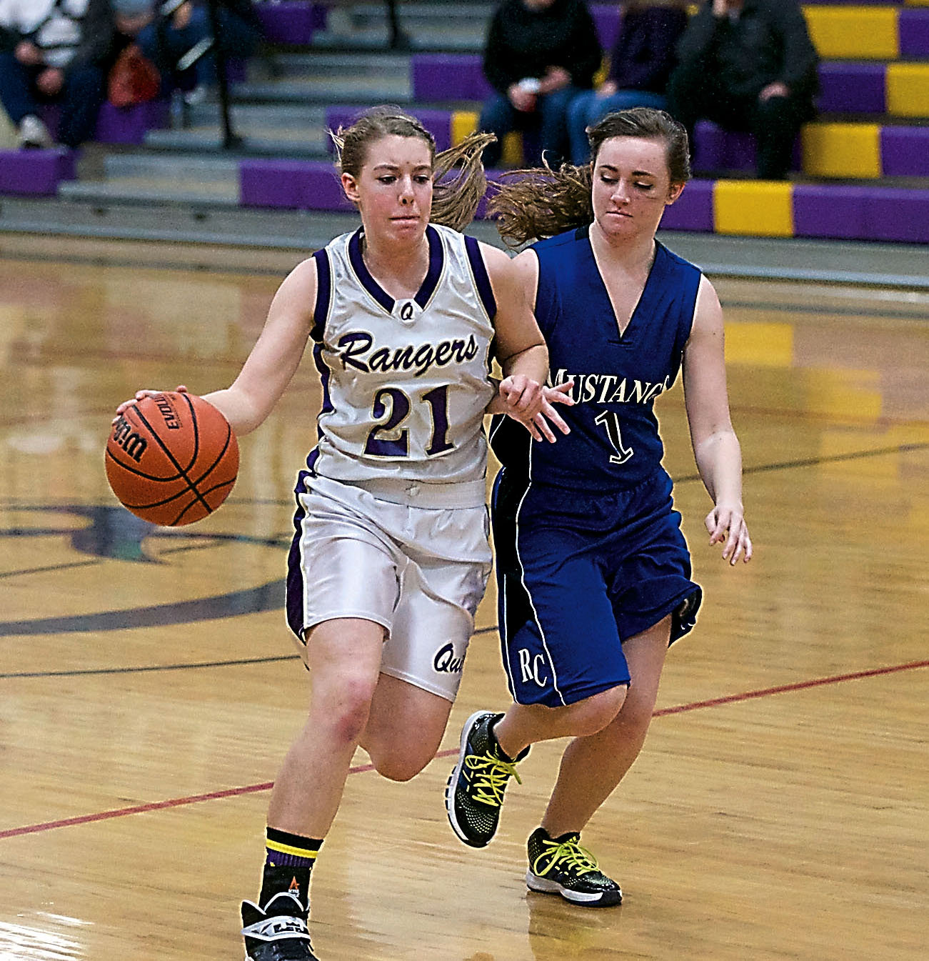 Quilcene's Megan Weller (21) dribbles past Rainier Christian's Heather Hoyt. Weller scored 10 points in the Rangers' 30-29 win. Steve Mullensky/for Peninsula Daily News