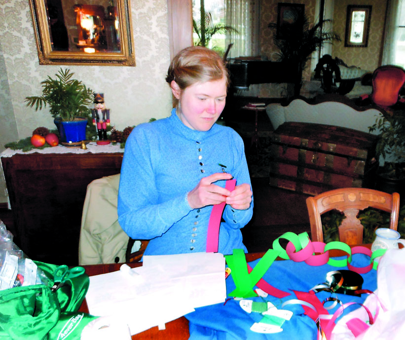 Sarah Chrisman makes decorations for the Yuletide Salon taking place at Flagship Landing in Port Townsend on Saturday.