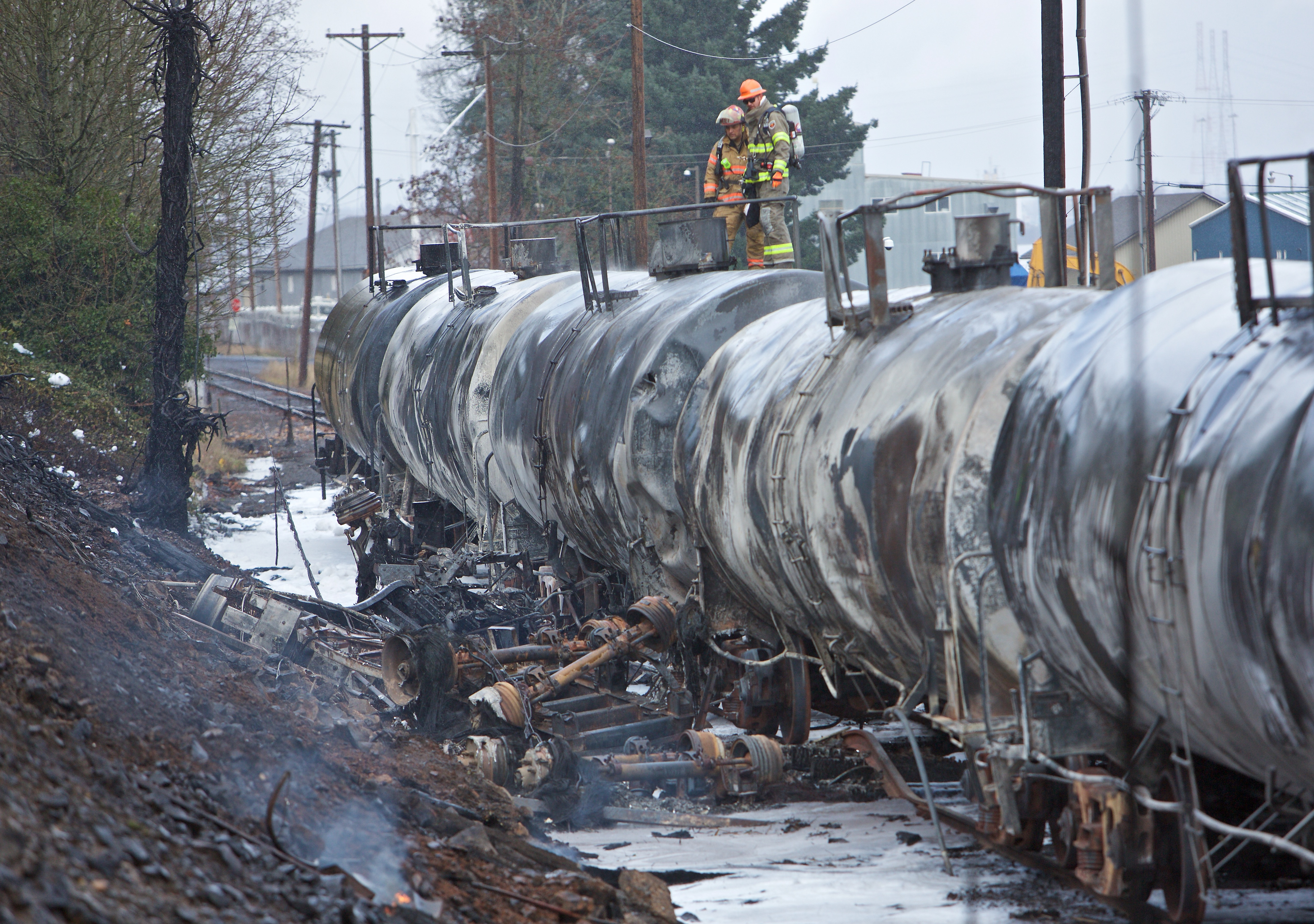 The remains of a fuel tanker truck that crashed into railroad cars is seen near the St. Johns Bridge in Portland
