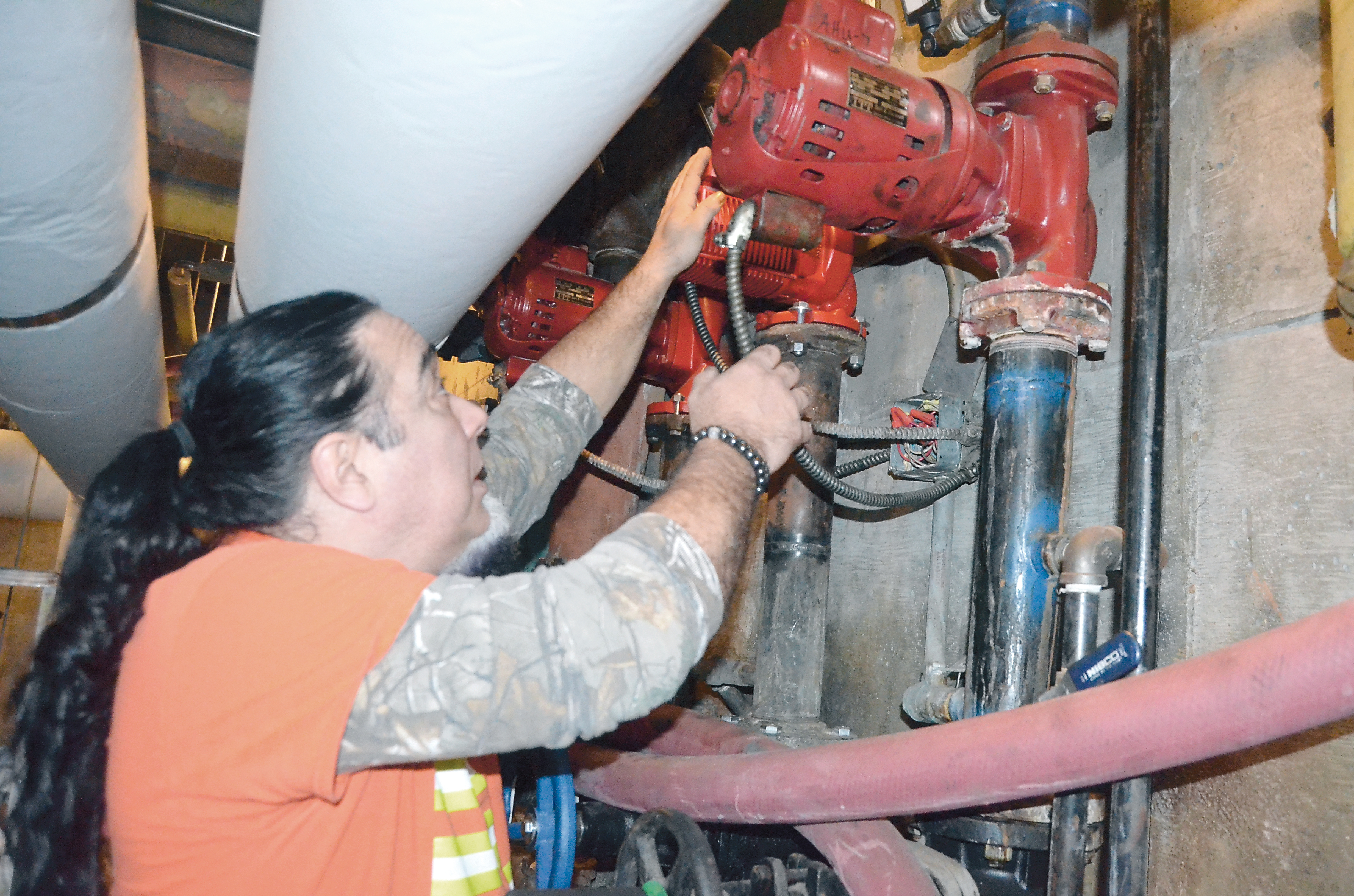 Heating contractor Billy Georgiadias tests the new pump at the pool at Mountain View Commons. Charlie Bermant/Peninsula Daily News