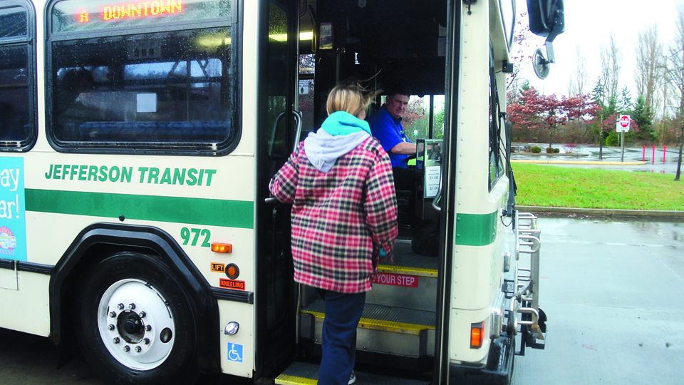 A rider boards a Jefferson Transit bus in Port Townsend. Due to budget constraints