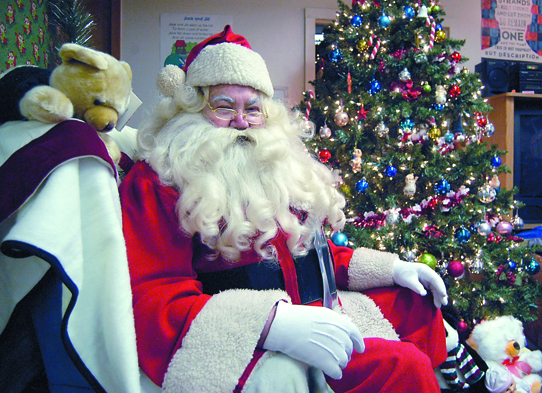 John Hubbard of Port Angeles waits to hear children's wishes at the Boys & Girls Clubs of Port Angeles. So many kids have sat on his knees