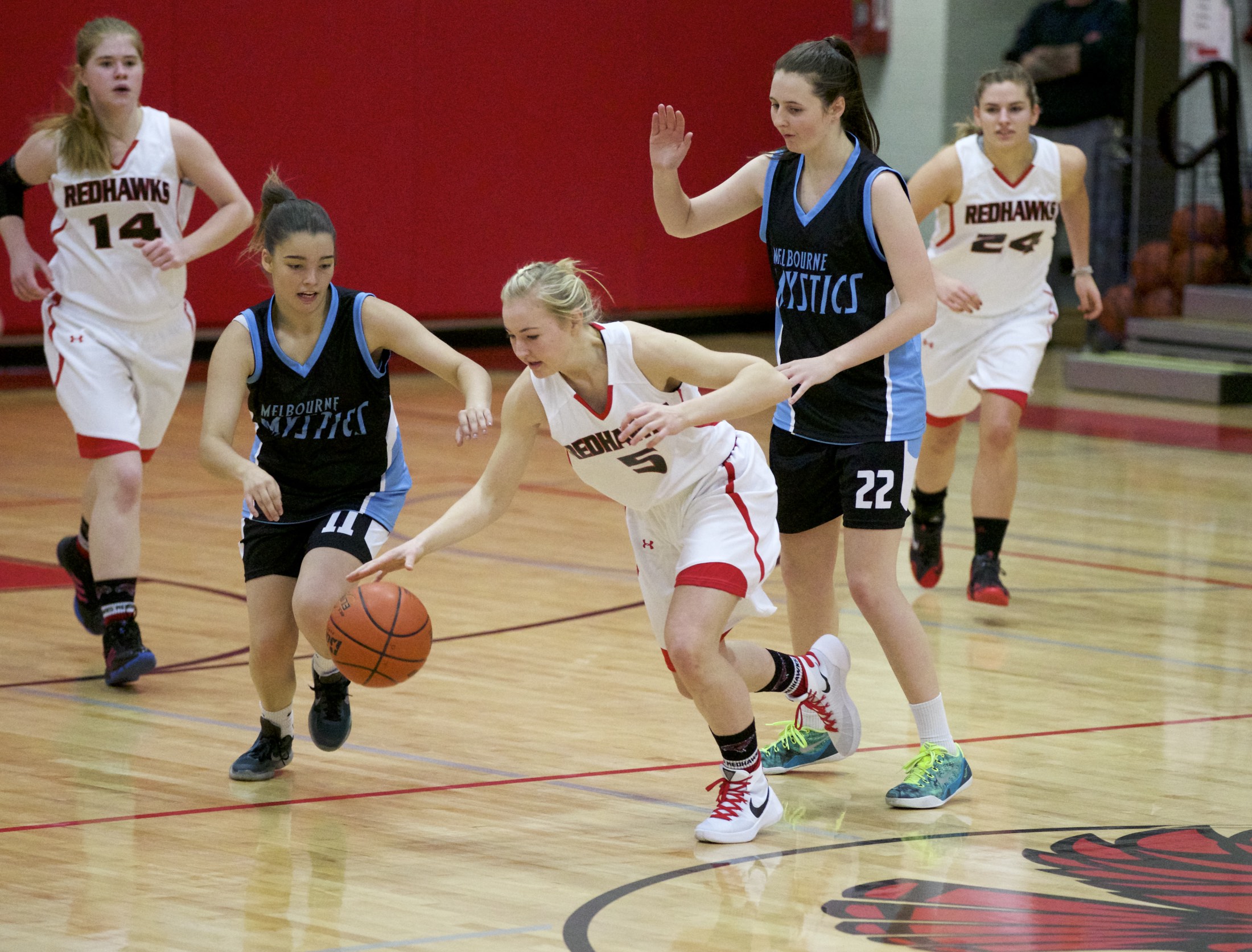 Port Townsend's Kaitlyn Meek dribbles while pressured by Melbourne's Zoe Kelty (11) and Alex McKellar during the Crush in the Slush tournament on Monday in Port Townsend. The Australian team cruised to a 65-28 victory. Boys and girls basketball action continues today at Port Townsend High School. Steve Mullensky/for Peninsula Daily News