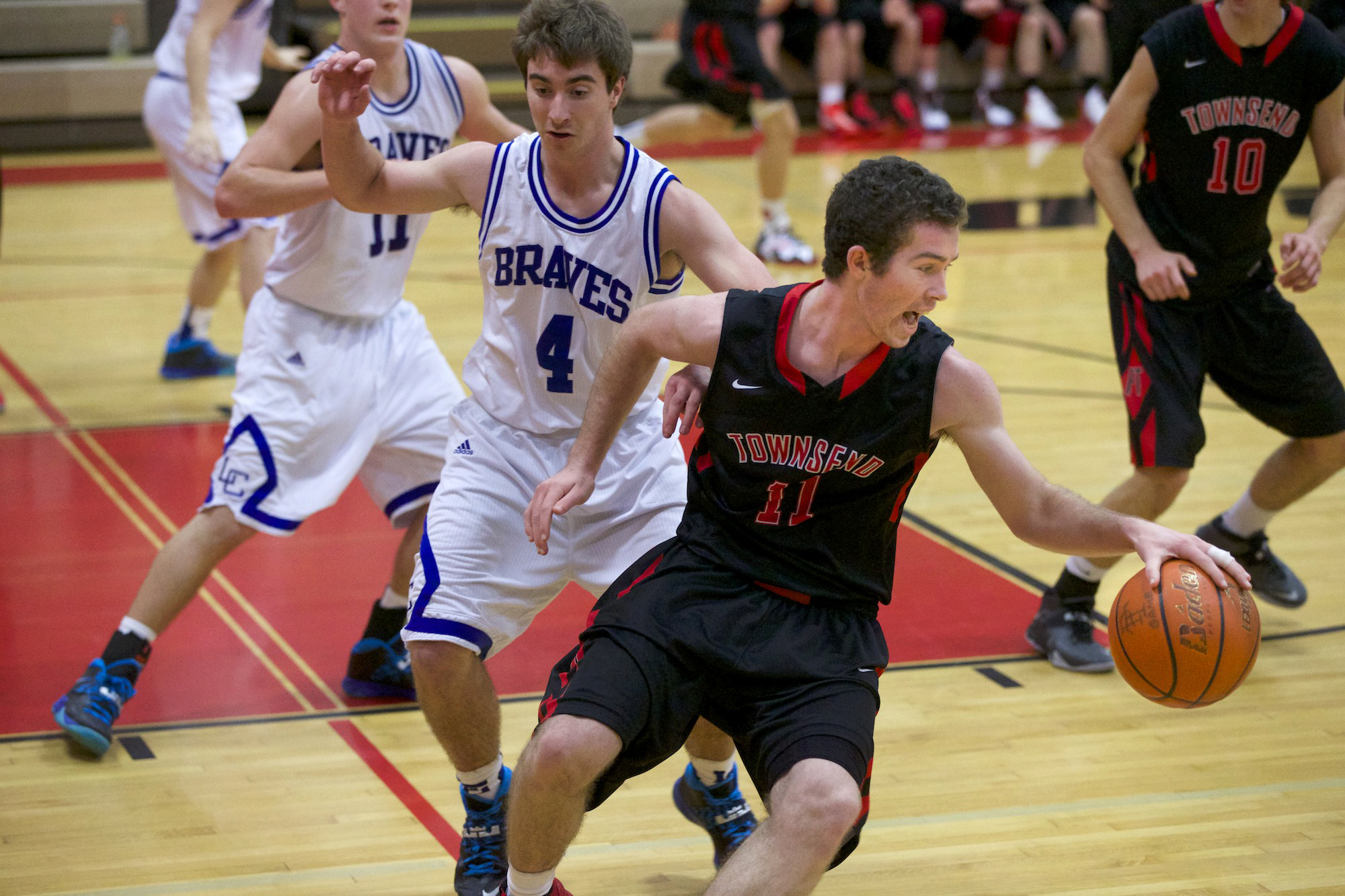 Port Townsend's Sean Dwyer (11) reverses direction around La Conner's Matt Finley during the small-school consolation game of the Crush in the Slush tournament at Port Townsend High School. Steve Mullensky/for Peninsula Daily News