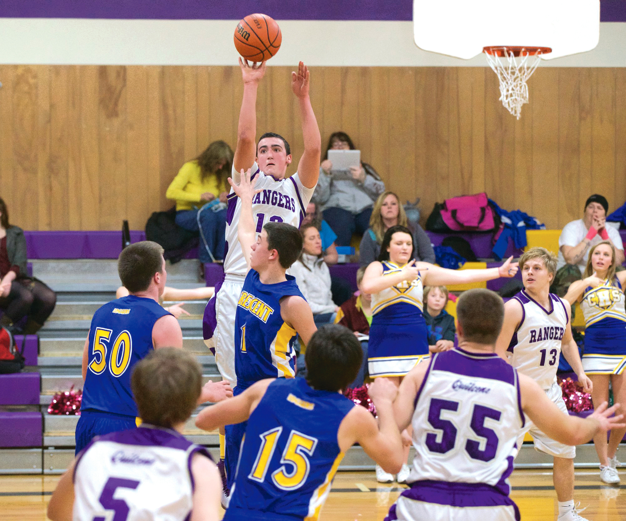Quilcene's Triston Williams hits a 3-pointer during the Rangers' nonleague win over the Crescent Loggers. Williams led all scorers with 17 points. Steve Mullensky/for Peninsula Daily News