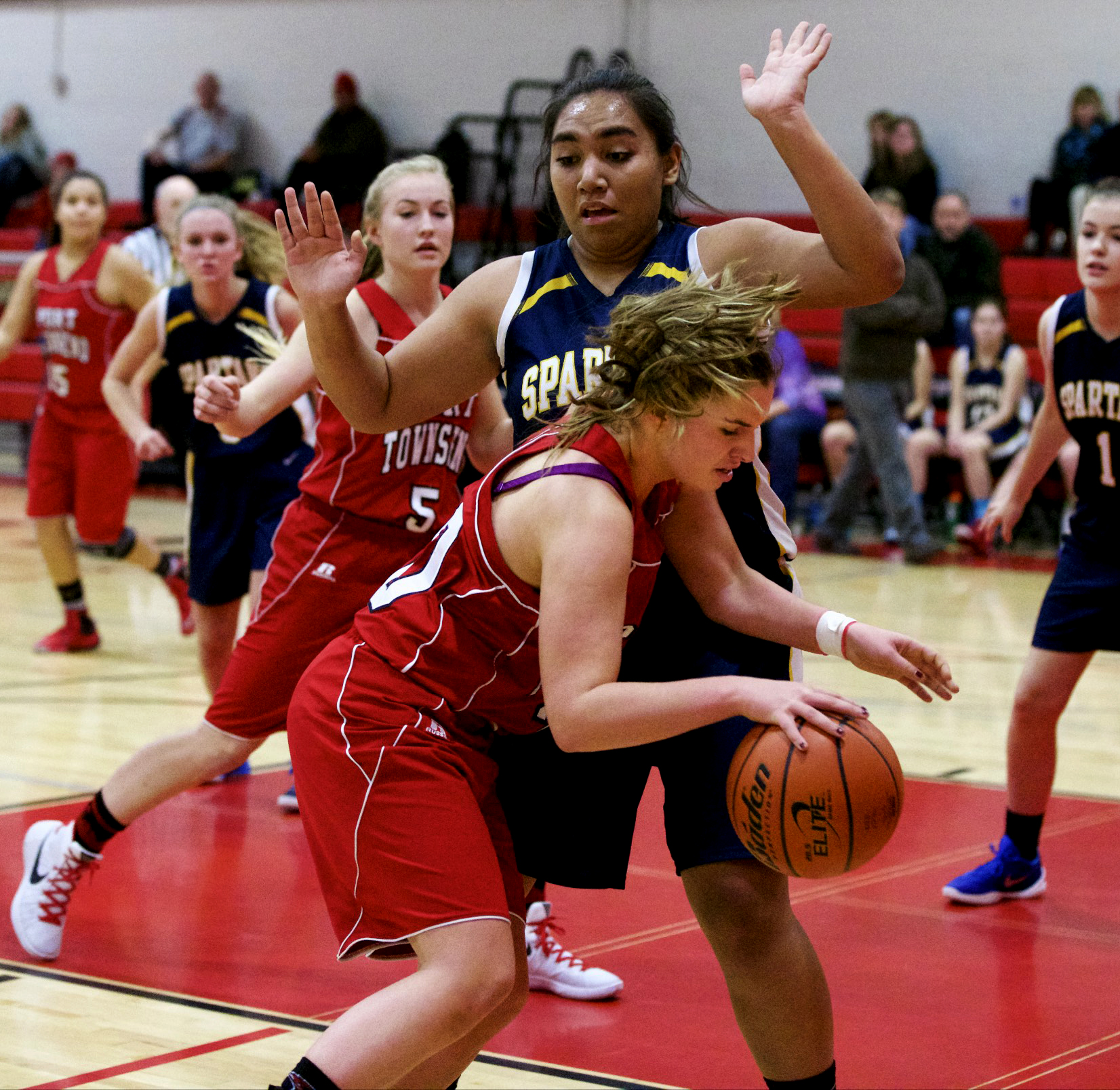 Port Townsend's Reilly Berkshire maneuvers in the post against Bainbridge's Malia Peato. Steve Mullensky/for Peninsula Daily News