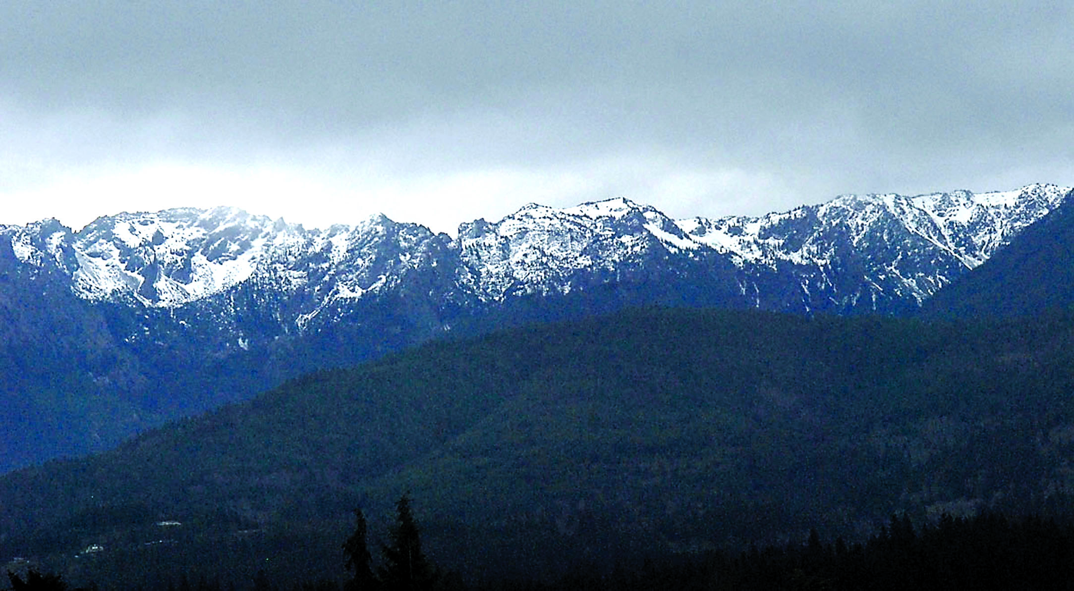 Snow dusts the northern face of Klahhane Ridge south of Port Angeles recently. Water content in the Olympic Mountain snowpack is at a mere 24 percent of normal levels. — Keith Thorpe/Peninsula Daily News