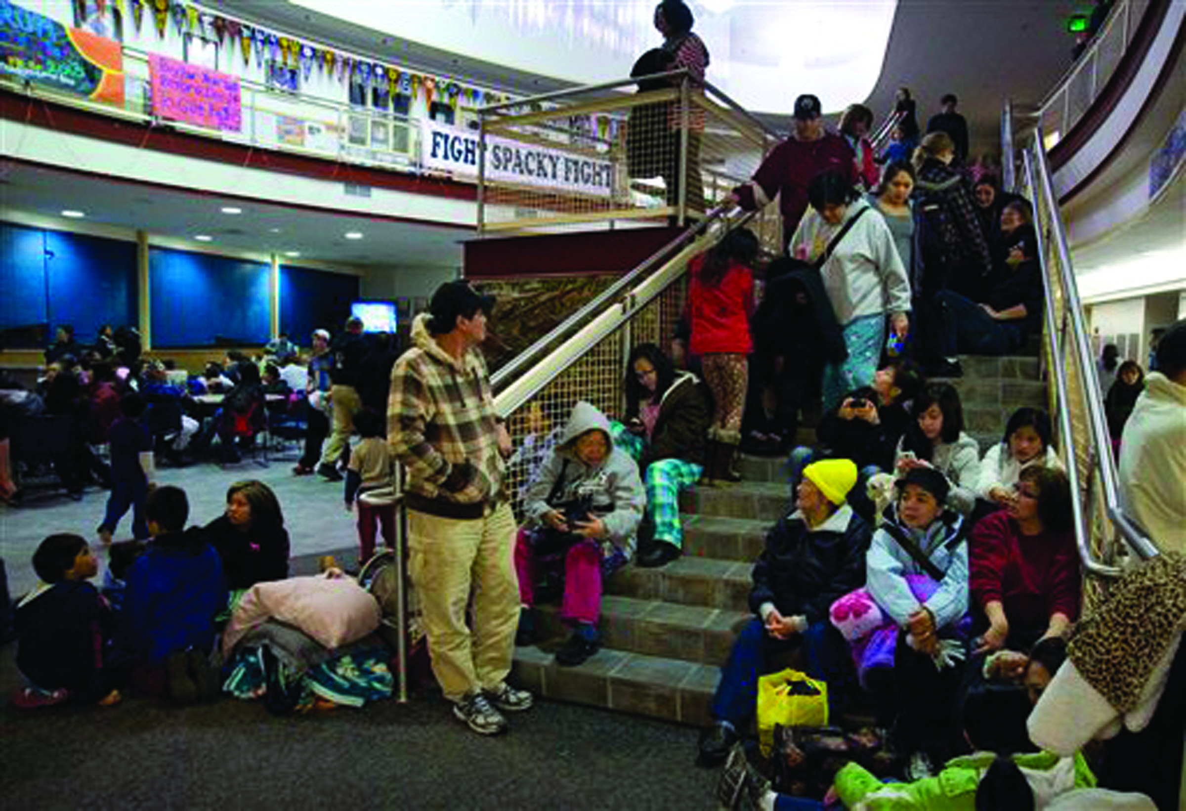 People gather at Sitka High School early today following a magnitude 7.5 earthquake and after a subsequent tsunami warning was declared for hundreds of miles of Alaskan and Canadian coastline. The alert was canceled when no damaging waves were generated.  -- The Associated Press