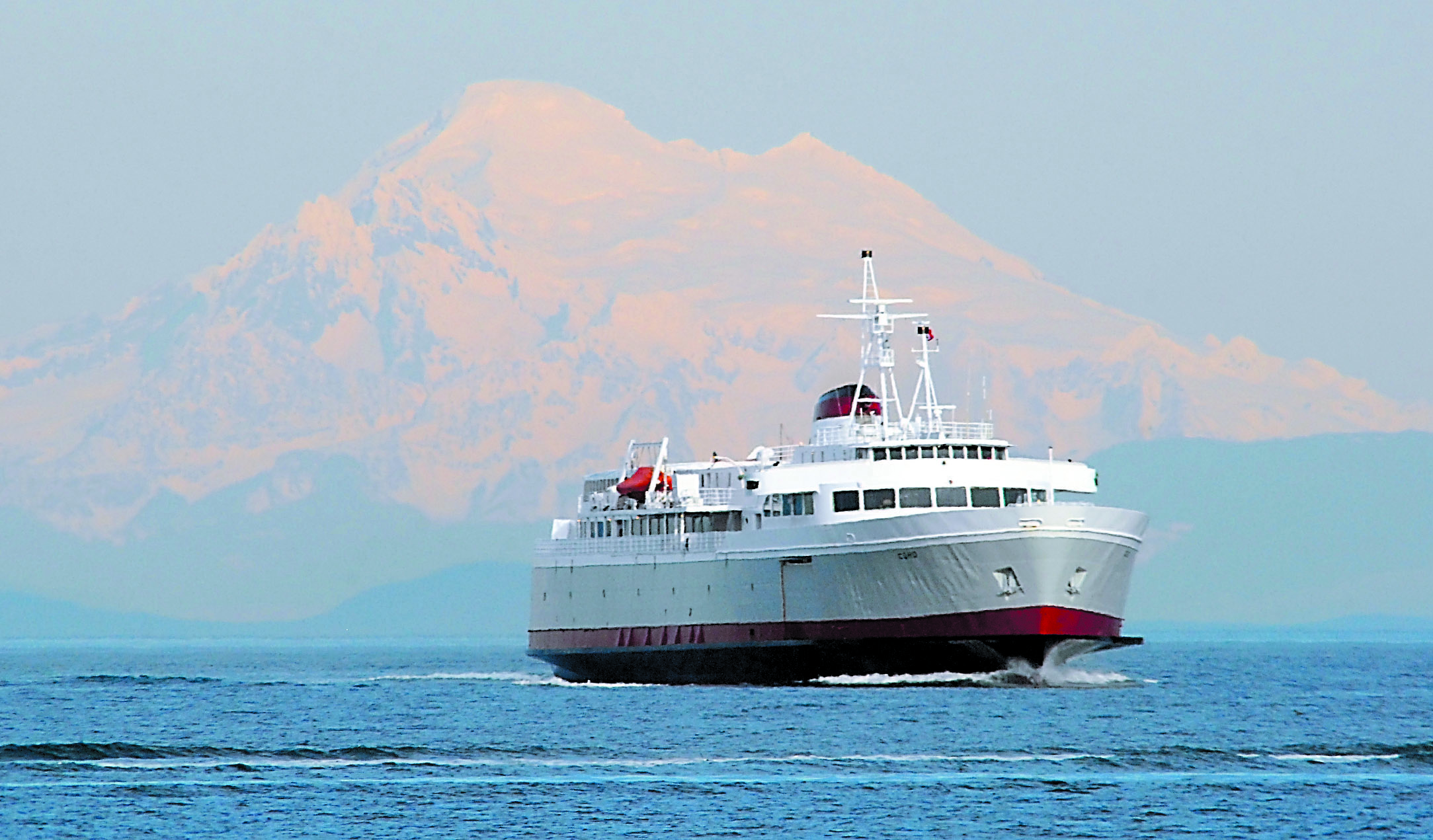 The MV Coho returns to Port Angeles Harbor — that's Mount Baker in the background — after last year's maintenance period.  -- Photo by Keith Thorpe/Peninsula Daily News