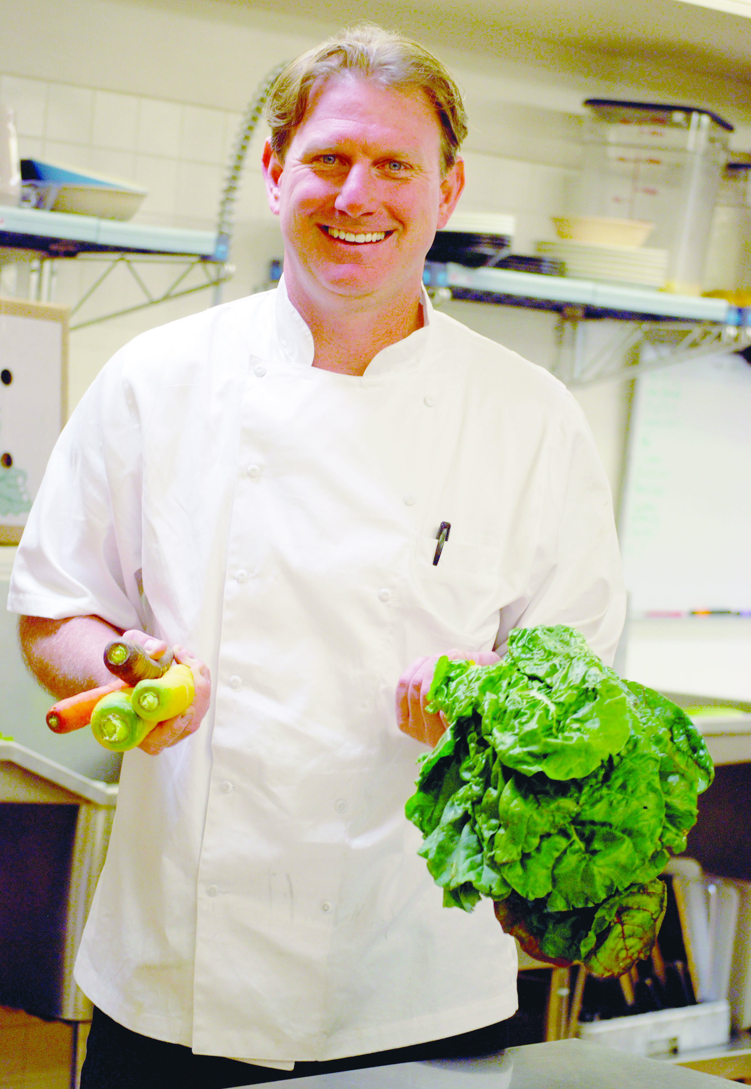 Arran Stark holds items grown at Nash’s Organic farm.  -- Photo by Diane Urbani de la Paz/Peninsula Daily News