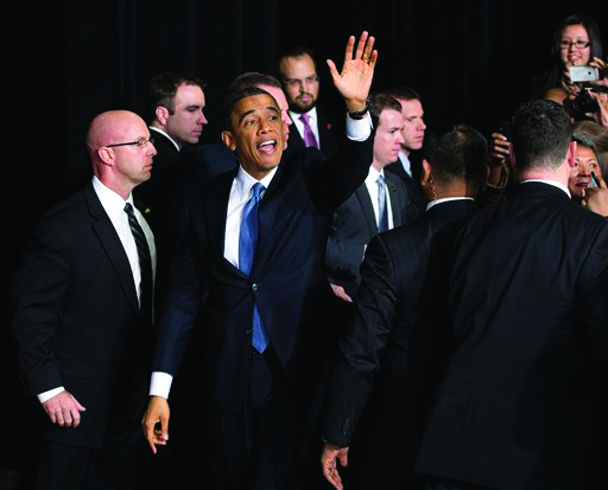 President Barack Obama waves as he leaves after shaking hands and speaking about immigration at Del Sol High School in Las Vegas. -- Photo by Carolyn Kaster/The Associated Press