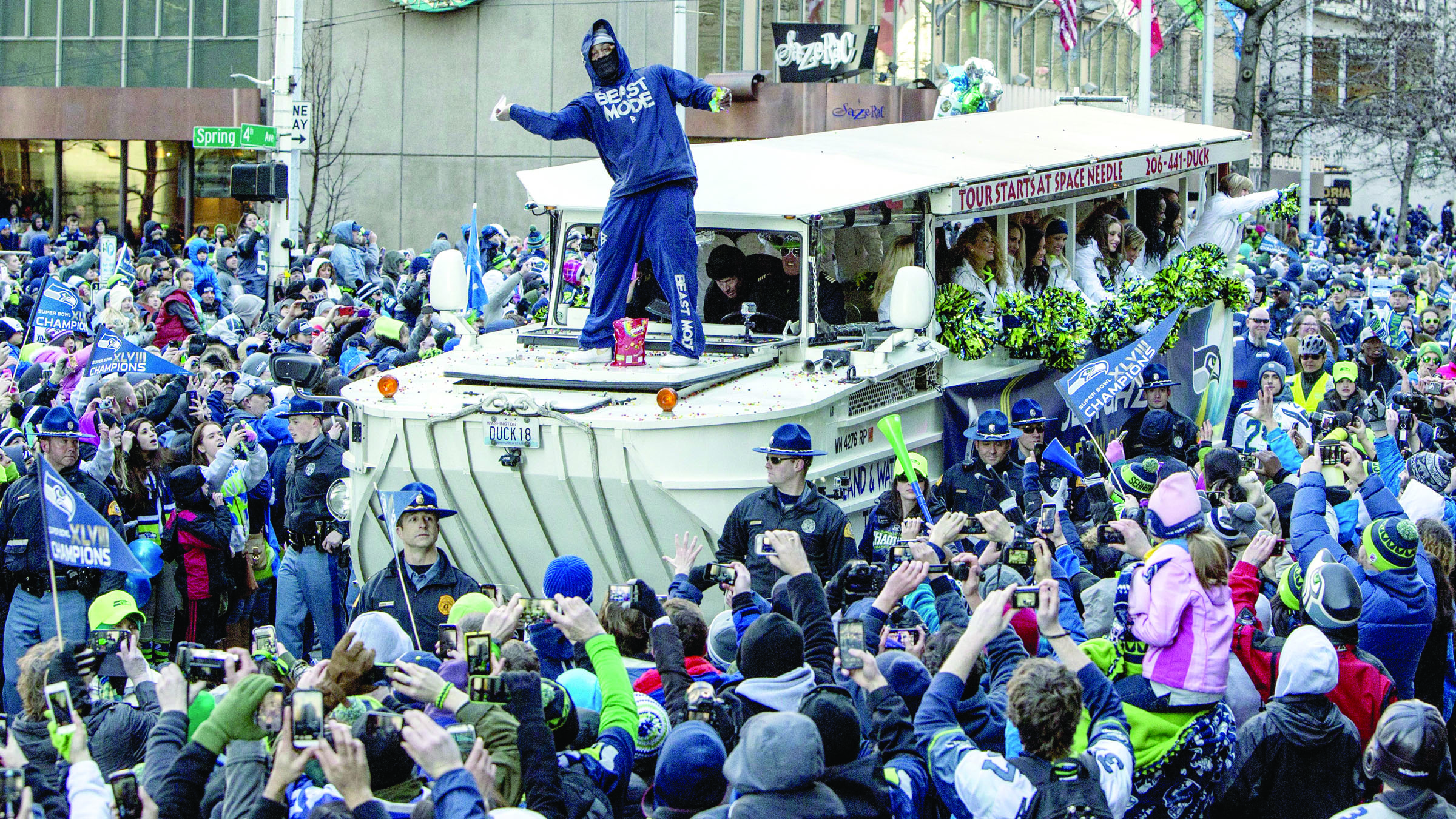 Seattle Seahawks running back Marshawn Lynch throws Skittles to fans during the parade for the NFL Super Bowl champions Wednesday in Seattle. Steve Ringman/The Seattle Times