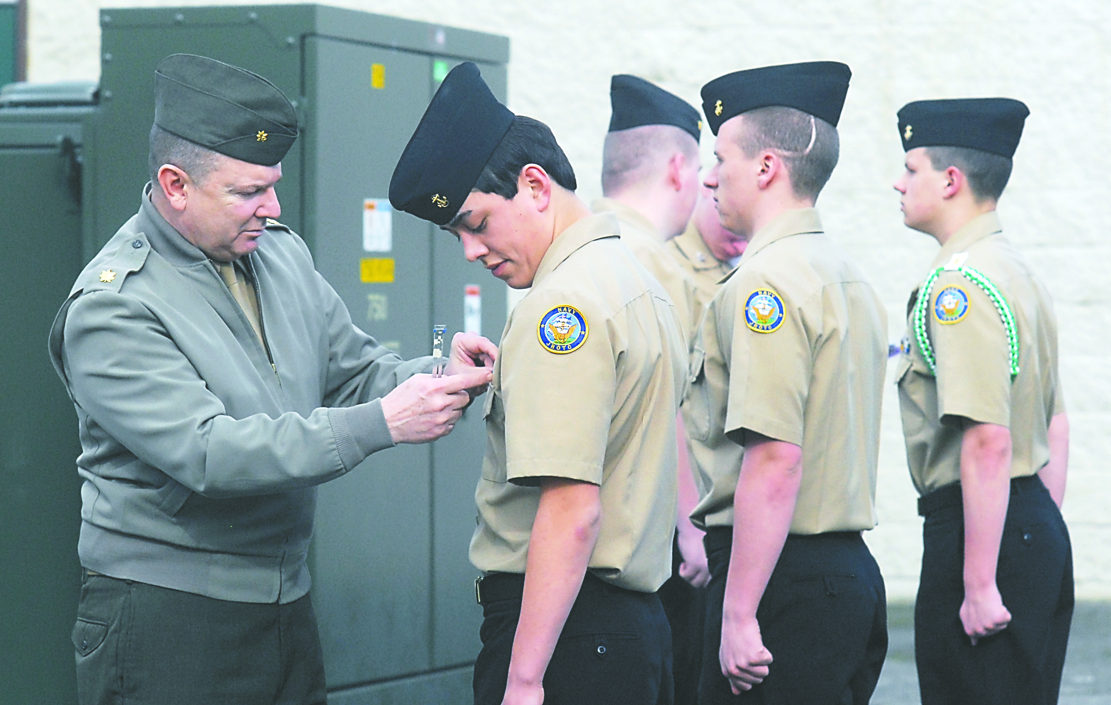 Port Angeles High School NJROTC instructor Maj. Leo Campbell reviews the uniform of student Robert Olea during a recent inspection.  -- Photo by Keith Thorpe/Peninsula Daily News