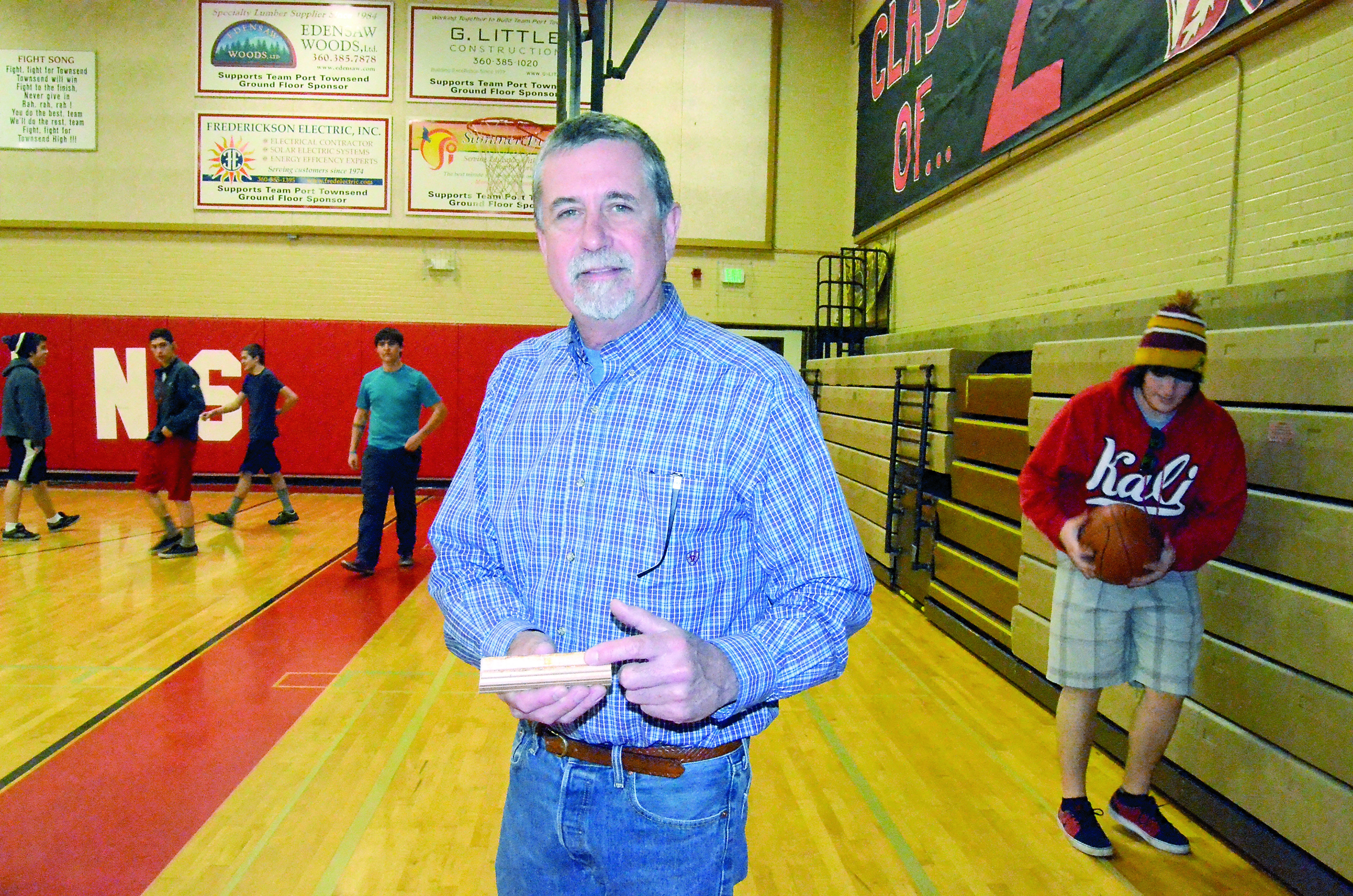 Port Townsend School District facilities director Brad Taylor shows there is life in the high school gym floor. Charlie Bermant/Peninsula Daily News
