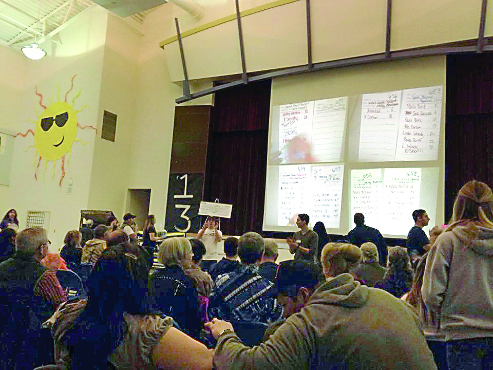 People bid Sunday in the Quillayute Valley Scholarship Auction at Forks High School. — Christi Baron/for Peninsula Daily News