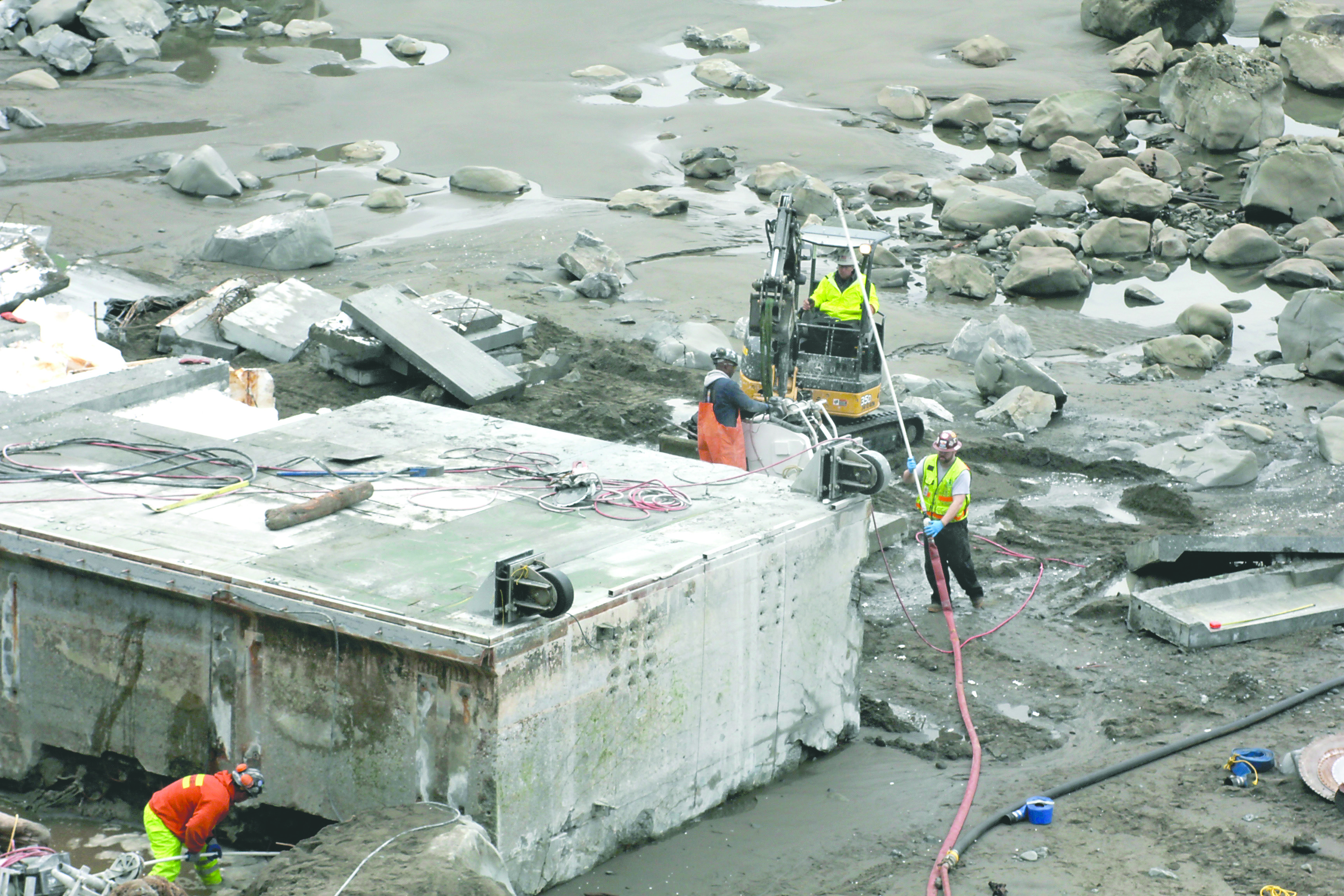Workers hack away at the dock that floated 4