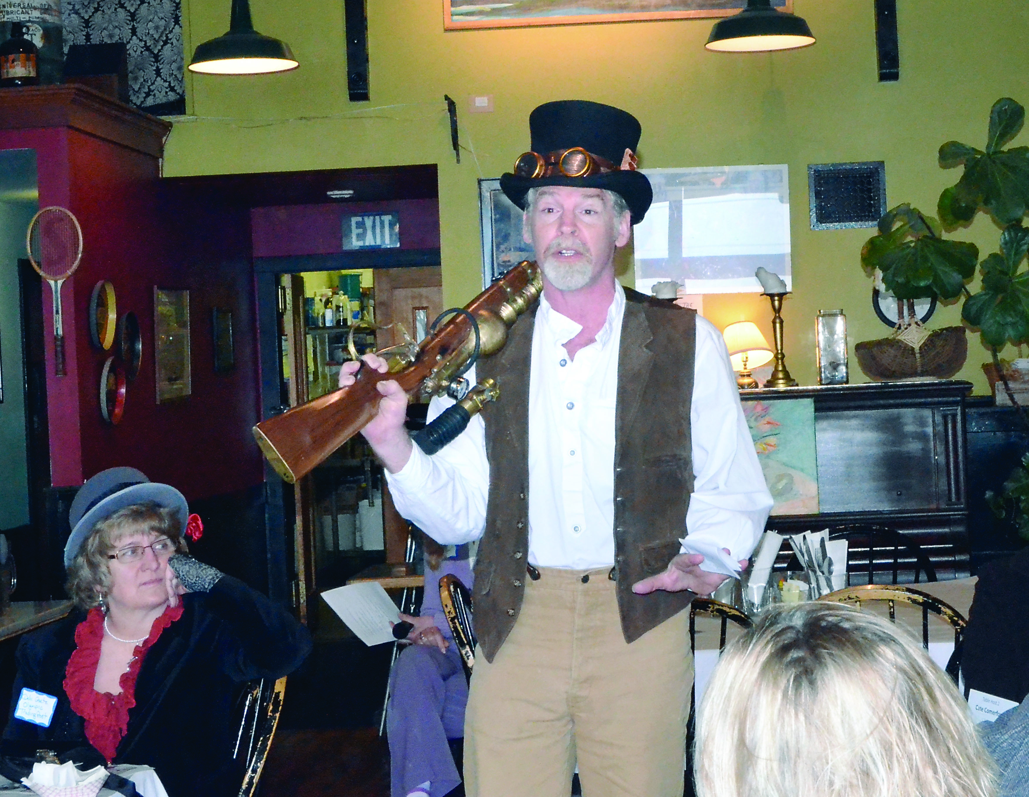 Olympic Steam director Nathan Barnett talks about the upcoming steampunk festival at a Main Street breakfast on Wednesday as Debi Goetz listens. — Charlie Bermant/Peninsula Daily News