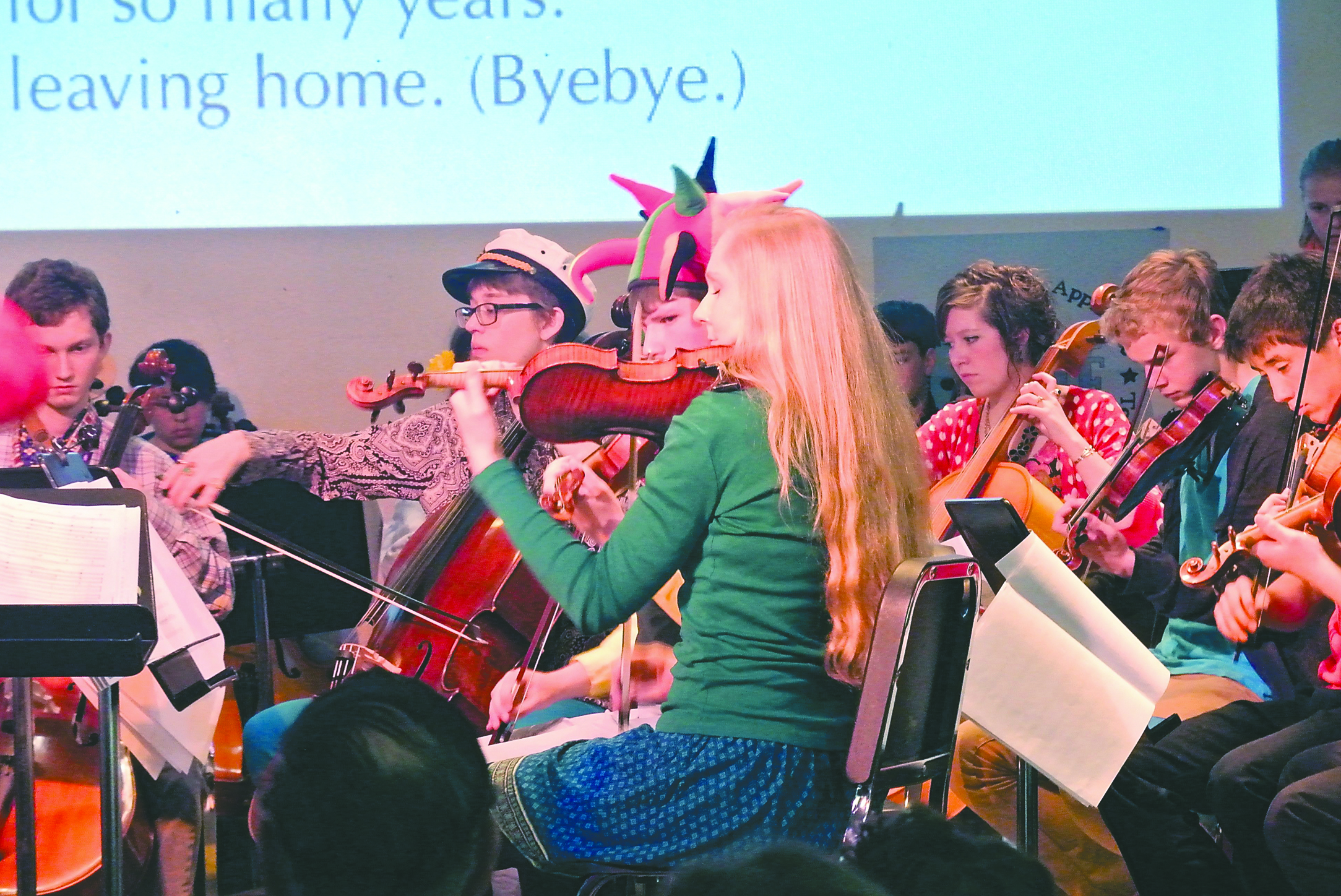 Members of the Port Townsend High School Orchestra perform music from the Beatles' “Sgt. Pepper's Lonely Hearts Club Band” as a sing-along. The words to “She's Leaving Home” are visible at top.  -- Photo by Charlie Bermant/Peninsula Daily News