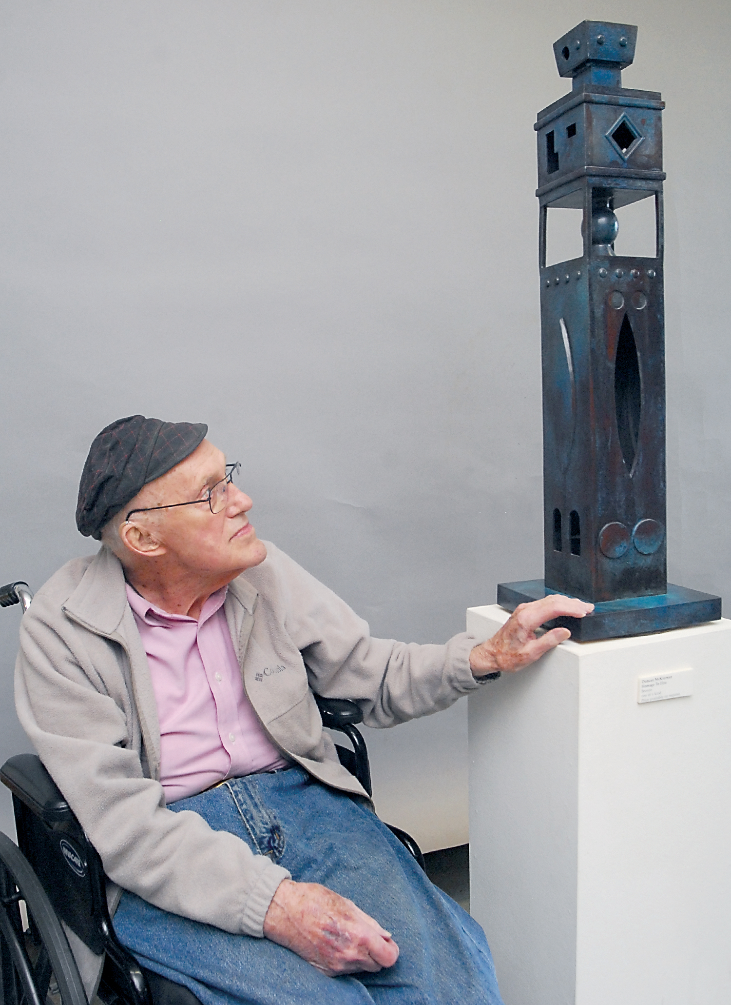Port Angeles sculptor Duncan McKiernan looks at his sculpture “Homage to Elza