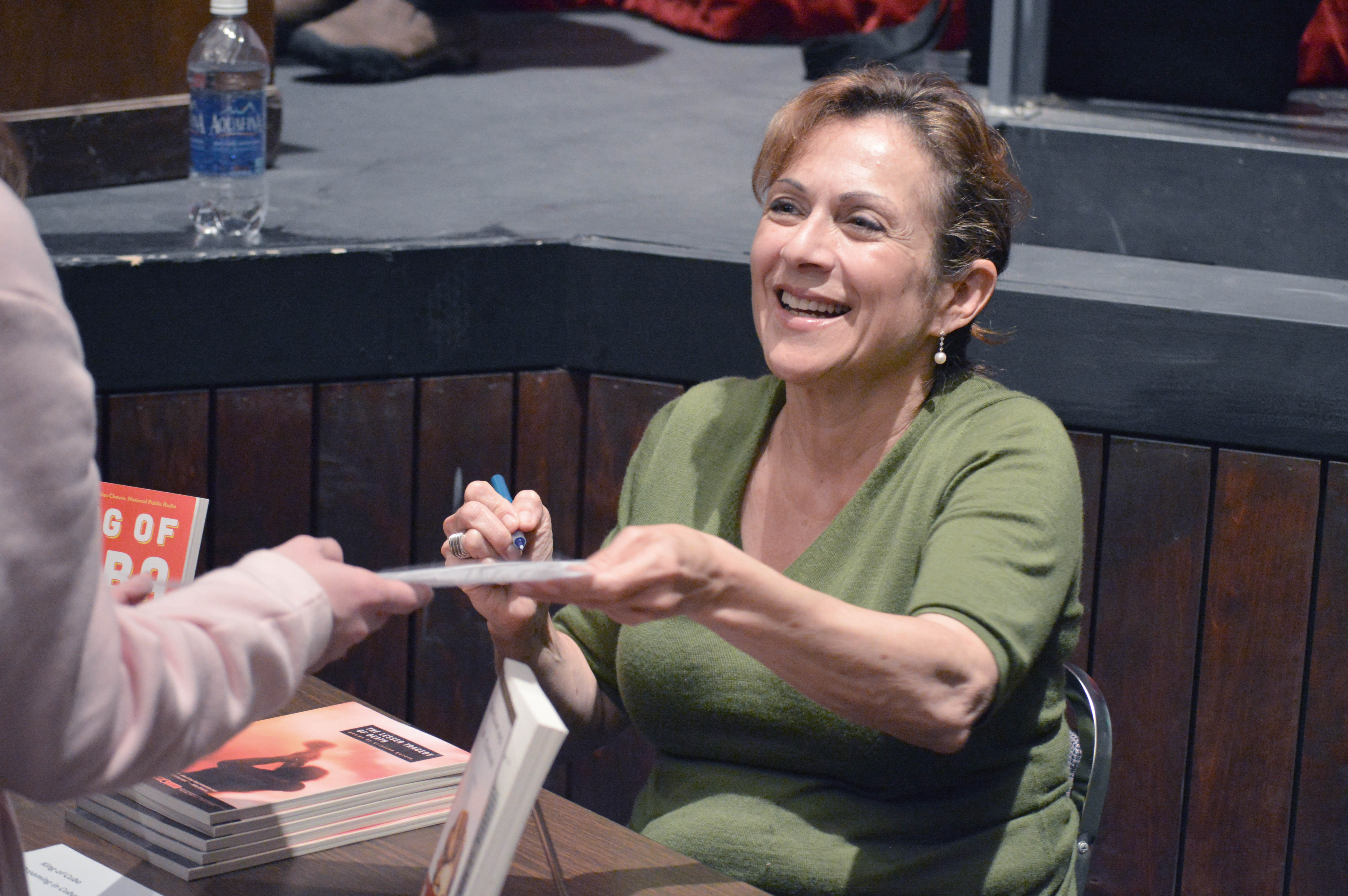 Novelist and Peninsula College Writer in Residence Cristina Garcia signs a flier for a student after her lecture on the Port Angeles campus.  —Photo by Diane Urbani de la Paz/Peninsula Daily News