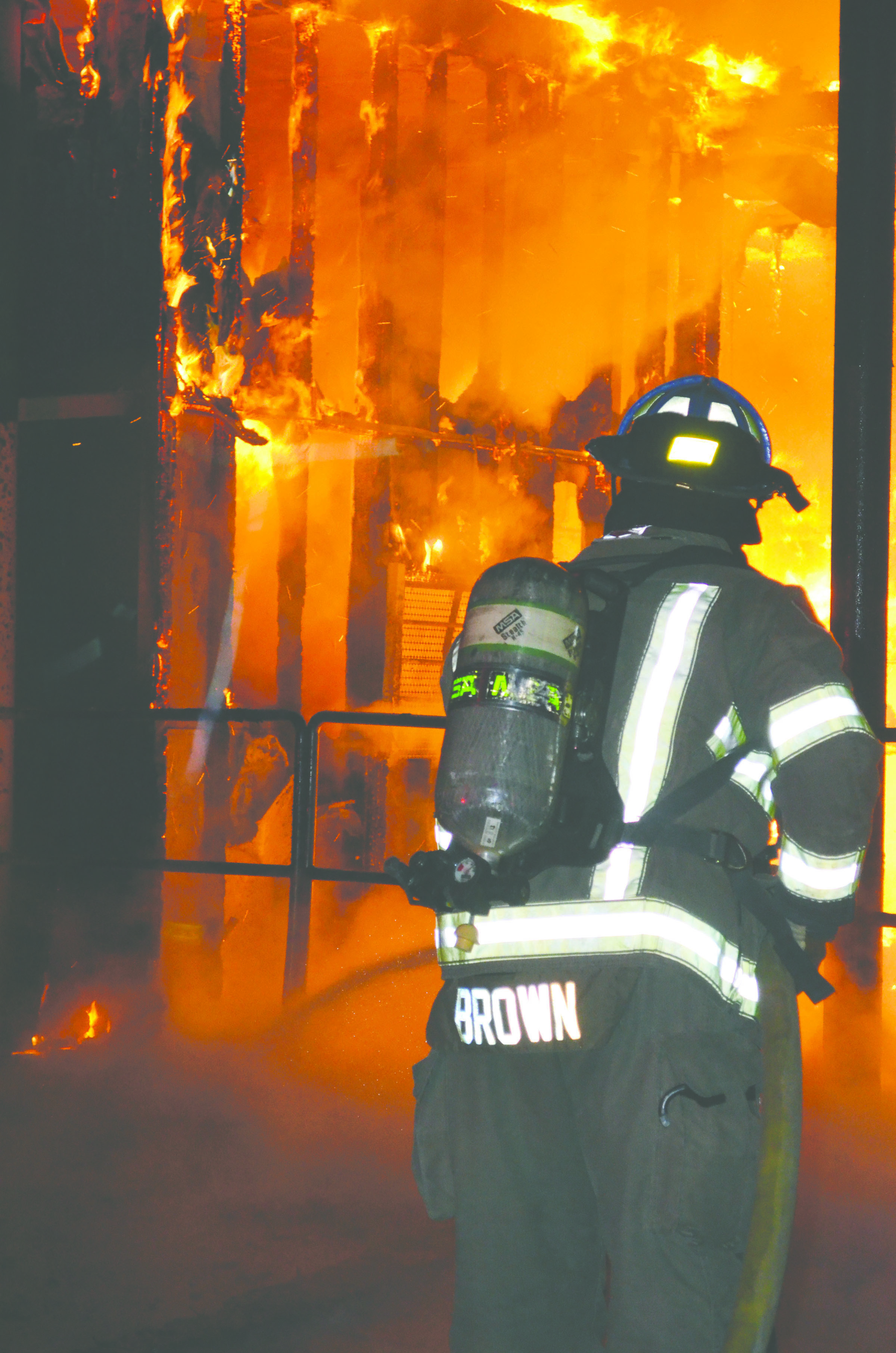 A firefighter with Clallam County Fire District No. 3 battles a blaze in a building at Blue Mountain Transfer Station in Port Angeles in November. — Patrick Young/Clallam County Fire District No. 3