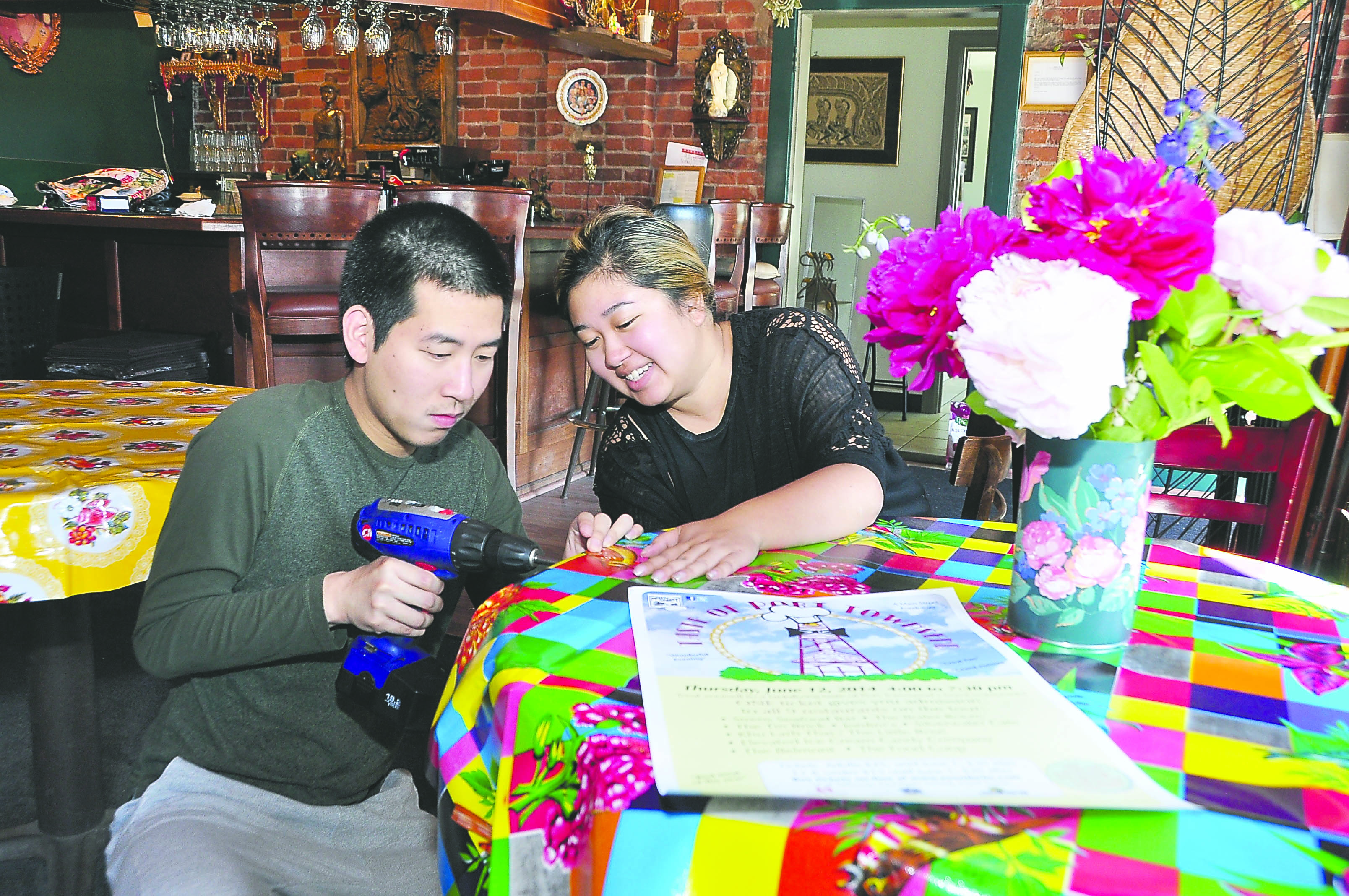 Mick Suwannalerd and Rosie Itti get Khu Larb Thai/Little Rose Restaurant ready for the Taste of Port Townsend on Thursday with new tablecloths purchased from What’s Cookin’ Kitchen Store in Port Townsend. — Elizabeth Becker/Seaport Photography