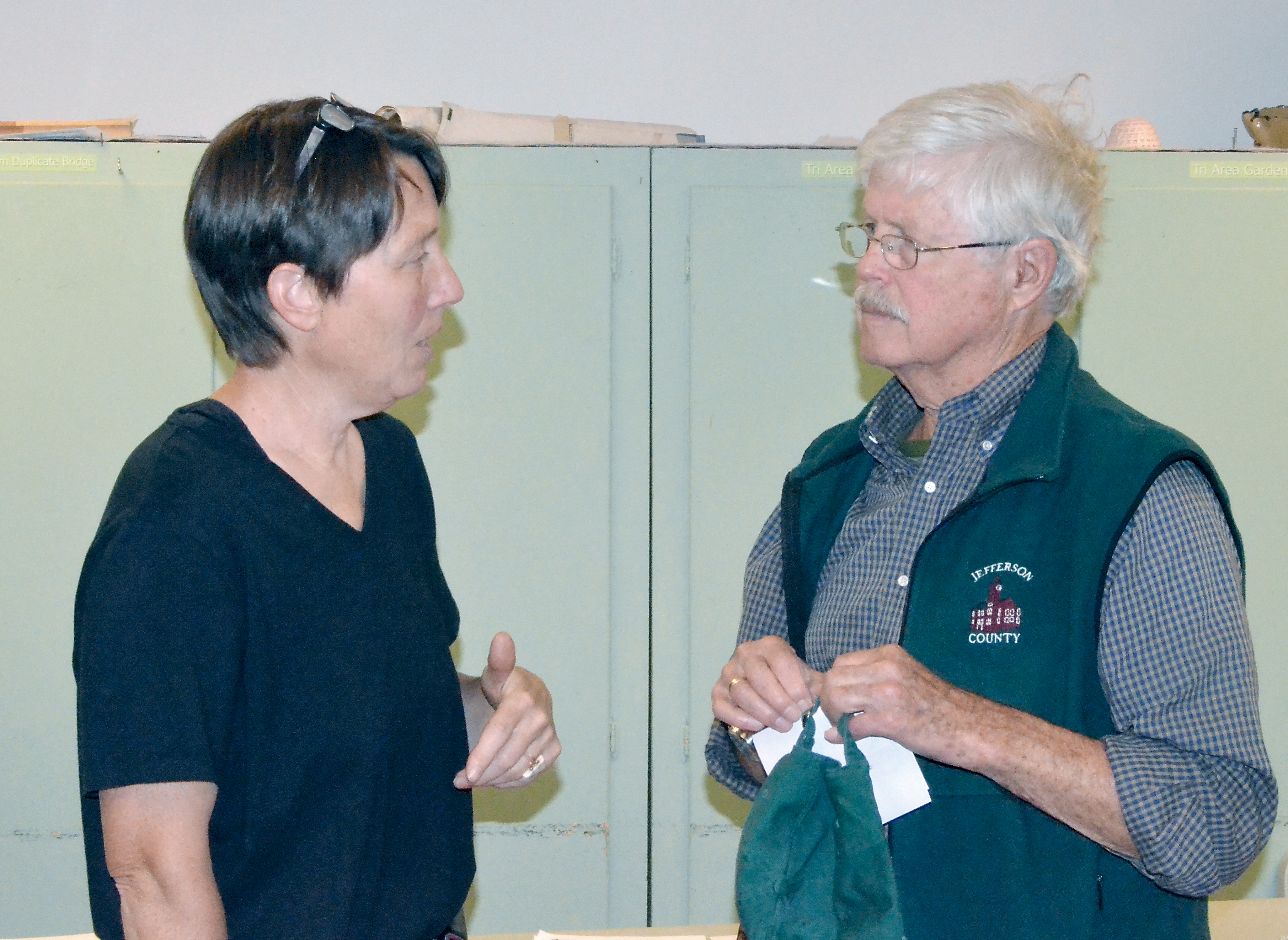 Karen Page chats with Jefferson County Commissioner John Austin prior to a meeting about marijuana regulations Wednesday night. Charlie Bermant/Peninsula Daily News