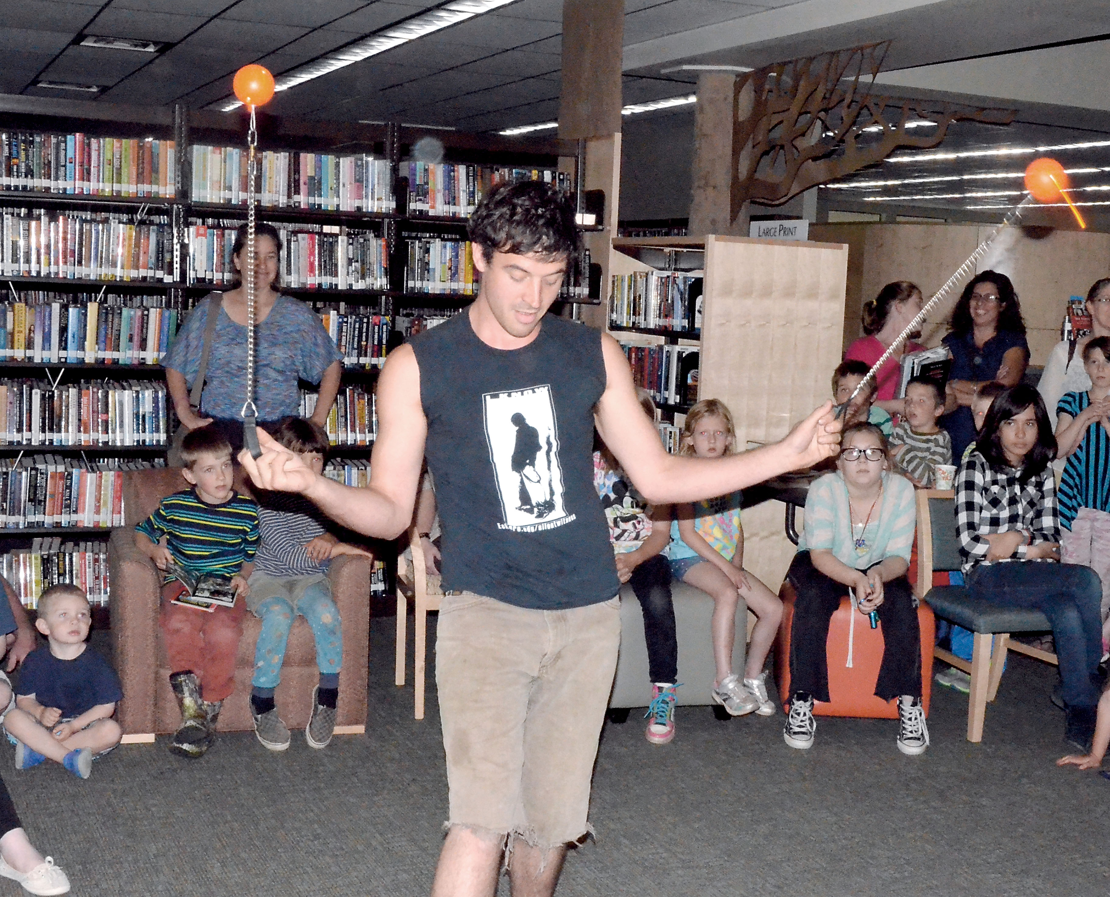 Chaz Hillyard performs for a group of about 50 kids at a kickoff event for the Jefferson County Library's summer reading program. Charlie Bermant/Peninsula Daily News