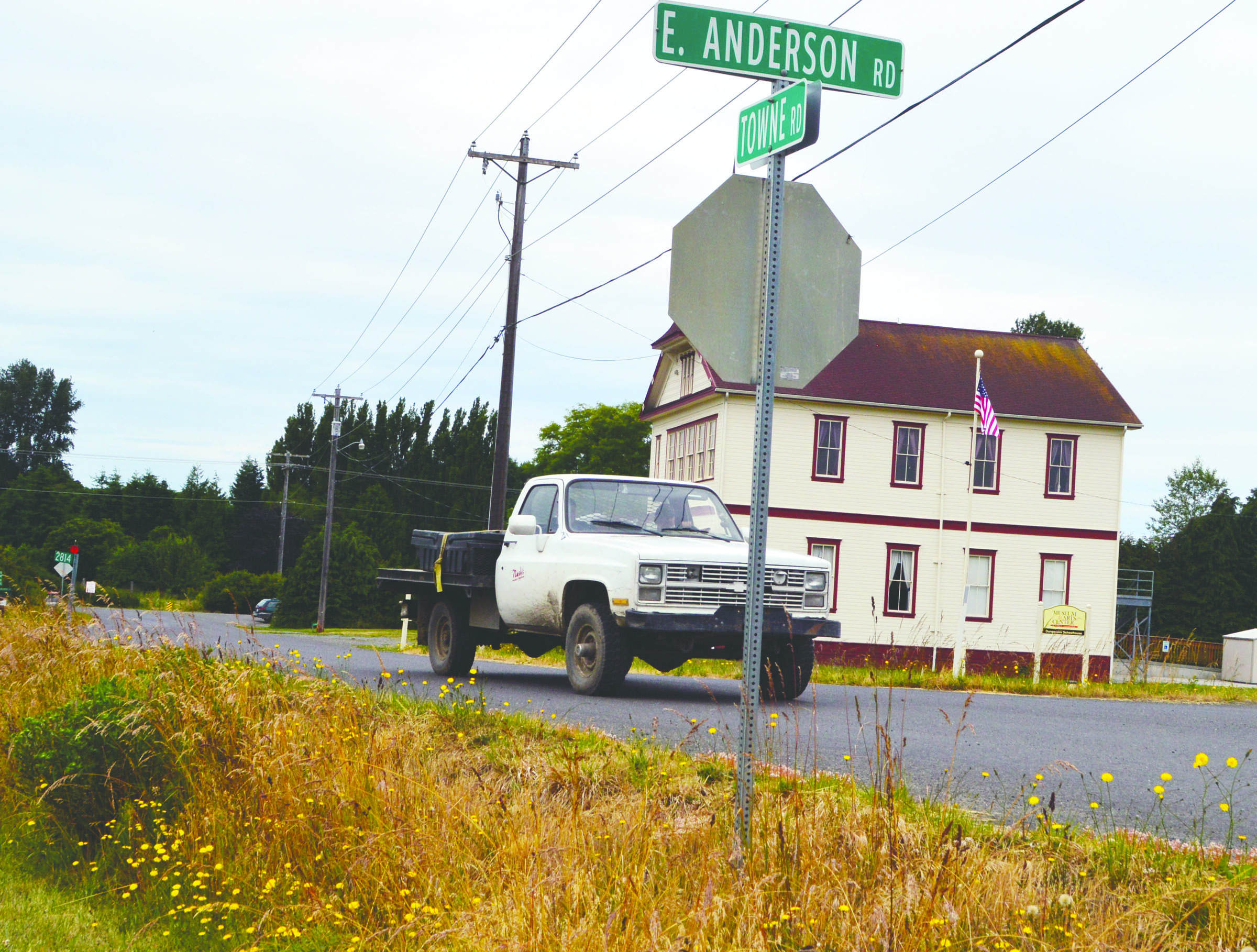 A truck drives along Towne Road near the Old Dungeness Schoolhouse on Monday. Clallam County commissioners are considering re-routing the road as upgrades are made to the Dungeness River levee that runs alongside Towne Road. — Joe Smillie/Peninsula Daily News