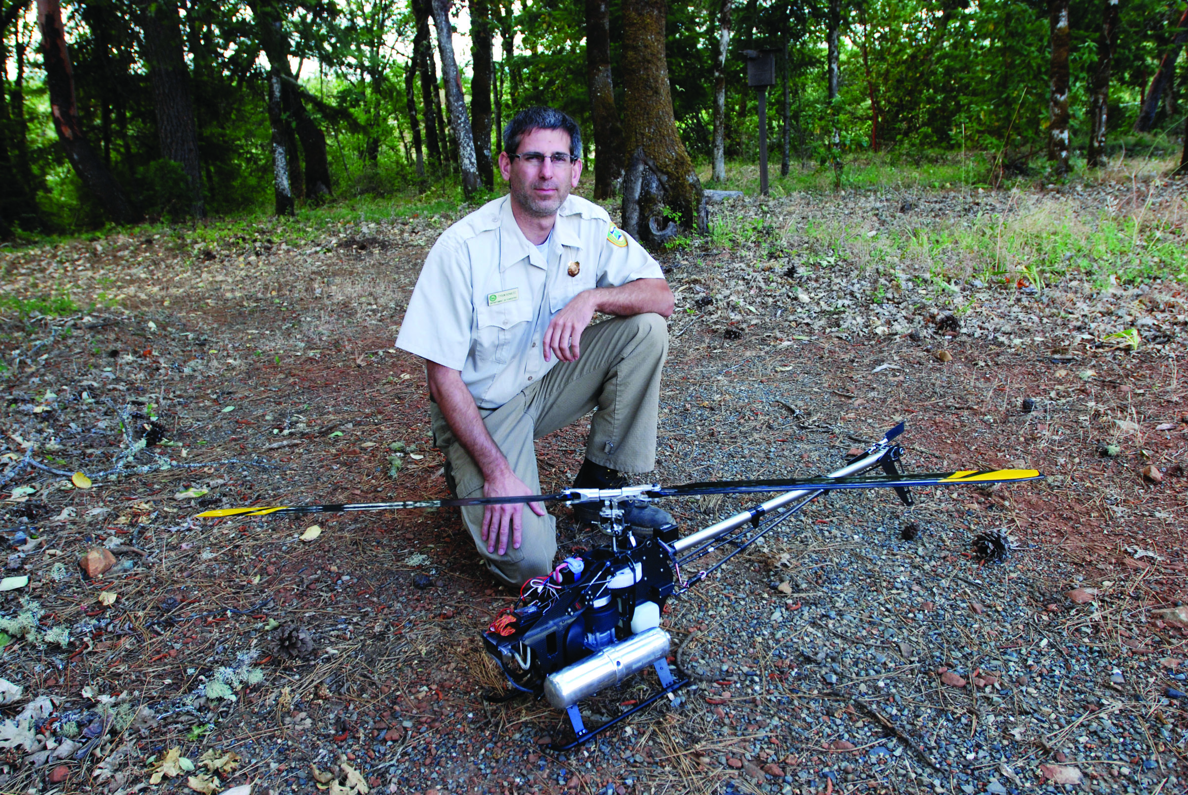 Tyson Shultz of the Oregon Department of Forestry is seen with a radio-controlled helicopter at the department’s compound on the outskirts of Grants Pass