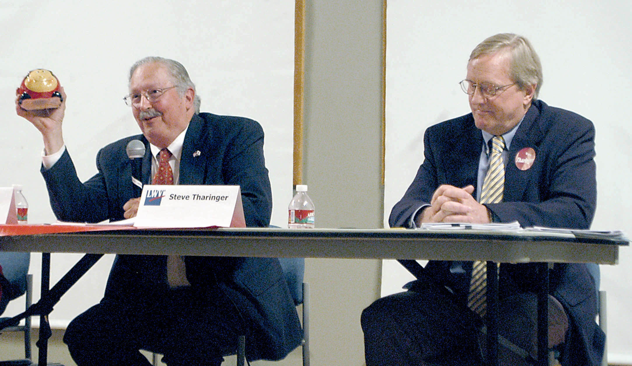 State representative candidate Thomas Greisamer uses a toy ladybug as a metaphor for how he intends to “clean up Olympia” if elected as incumbent state Rep. Steve Tharinger looks on during a Clallam County League of Women Voters forum Wednesday in Port Angeles. — Rob Ollikainen/Peninsula Daily News