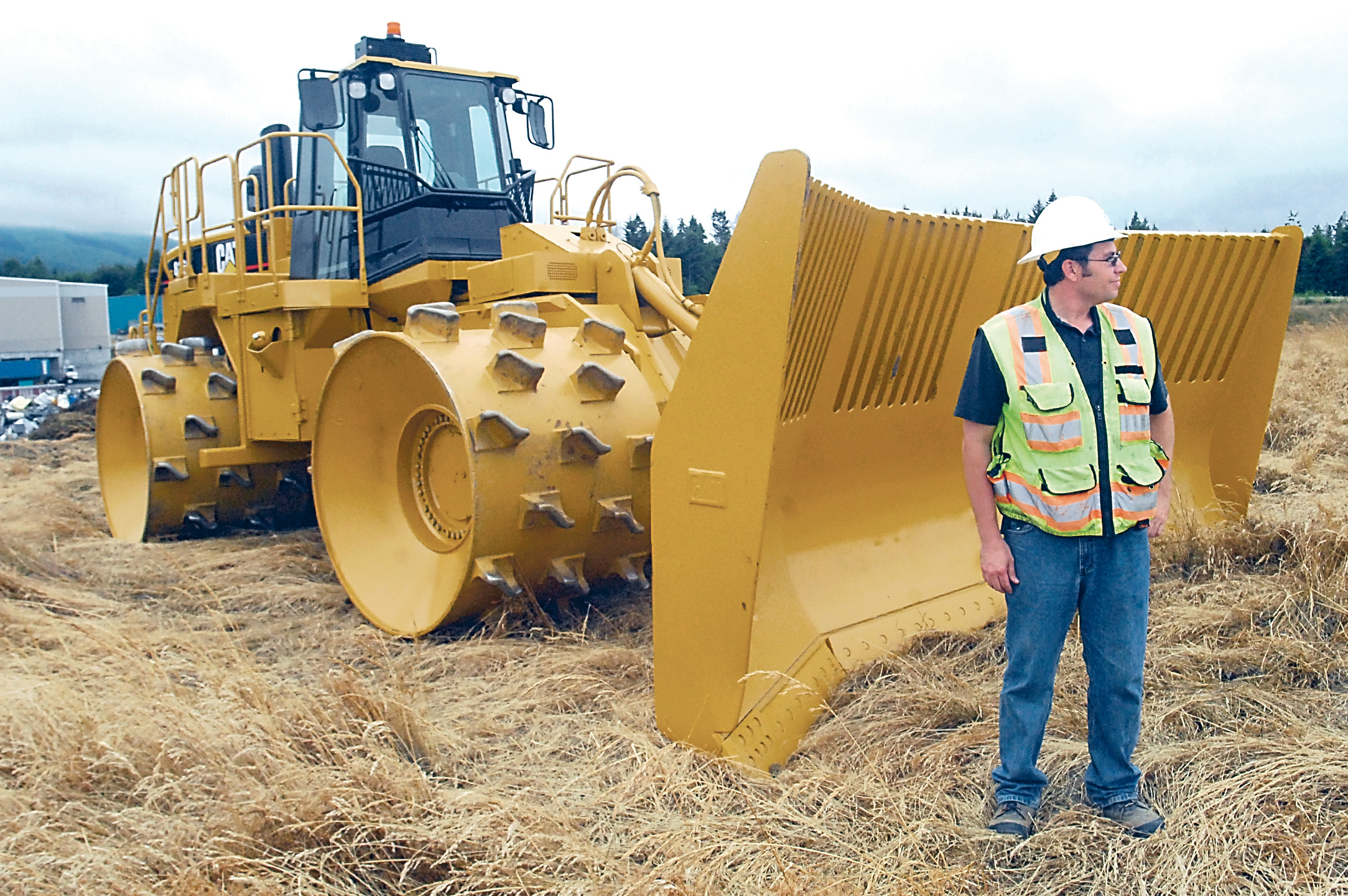 Port Angeles Public Works Inspector Jeremy Pozernick stands next to a trash compactor at the former landfill in Port Angeles. Keith Thorpe/Peninsula Daily News