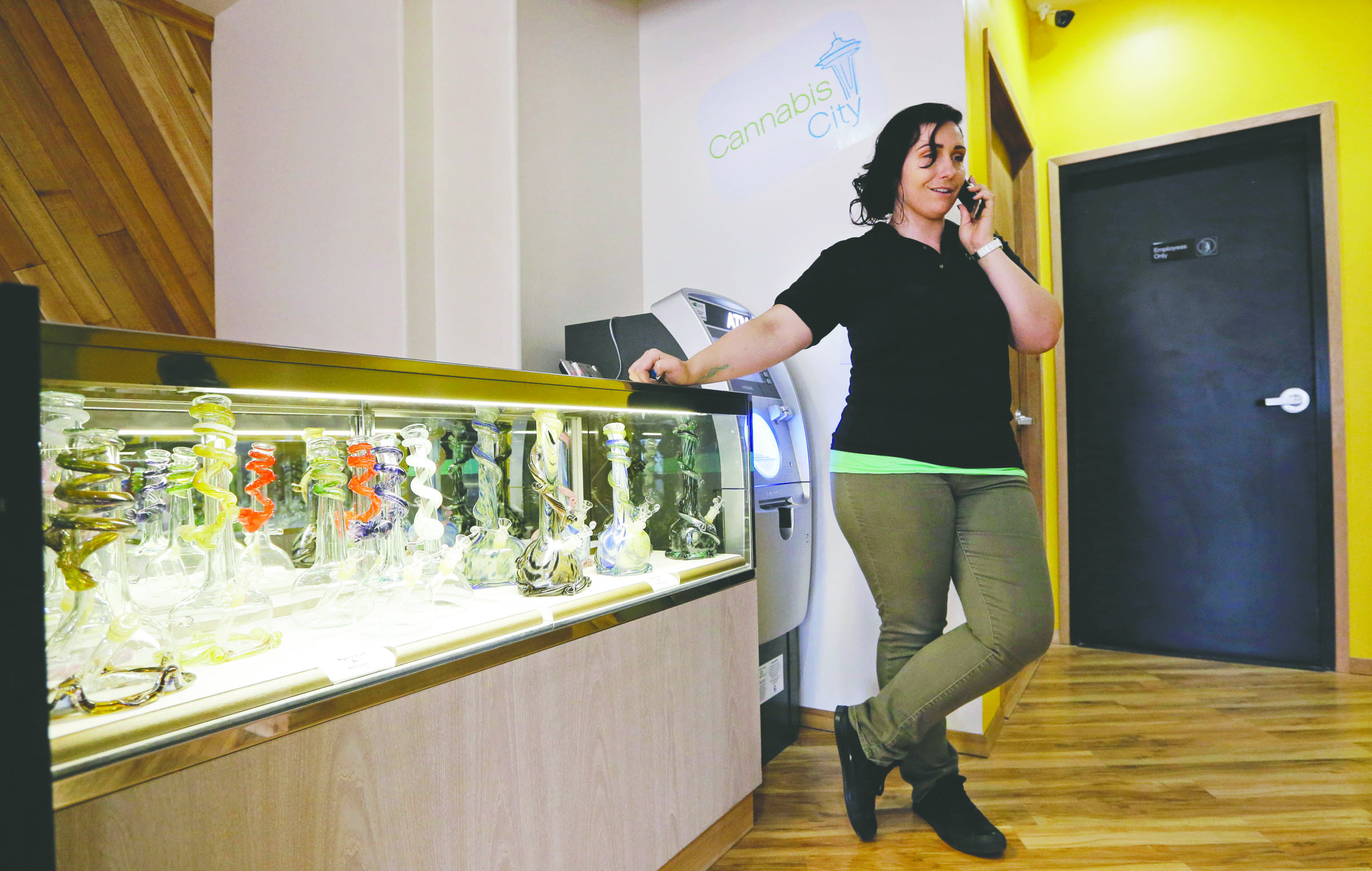 Cannabis City manager Amber McGowan takes the marijuana shop’s first call from a potential customer days before the grand opening last week in Seattle. The store expects to begin selling pot Tuesday. — The Associated Press