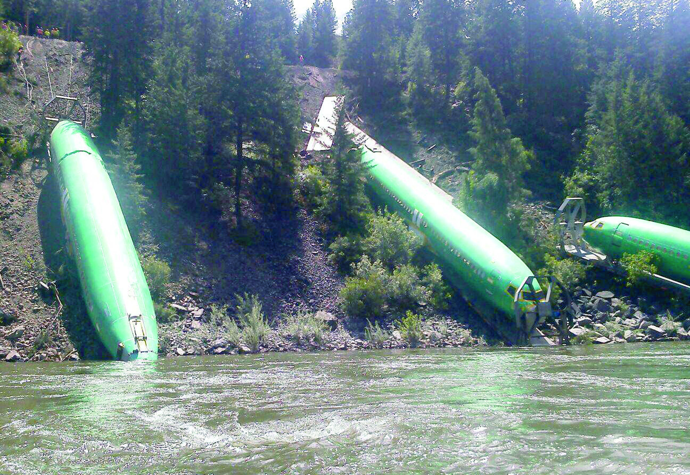 Three Boeing 737 fuselages lie on the embankment of Clark Fork River near Alberton