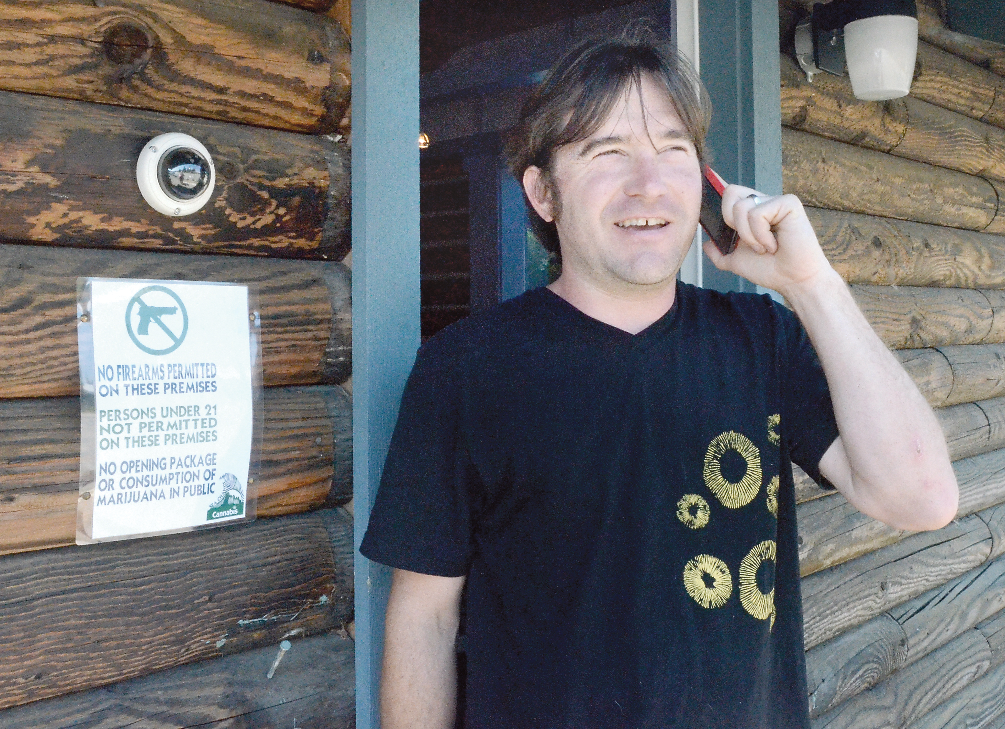 Greg Brotherton talks to a supplier in preparation for opening the North Olympic Peninsula’s first recreational pot store Saturday. — Charlie Bermant/Peninsula Daily News