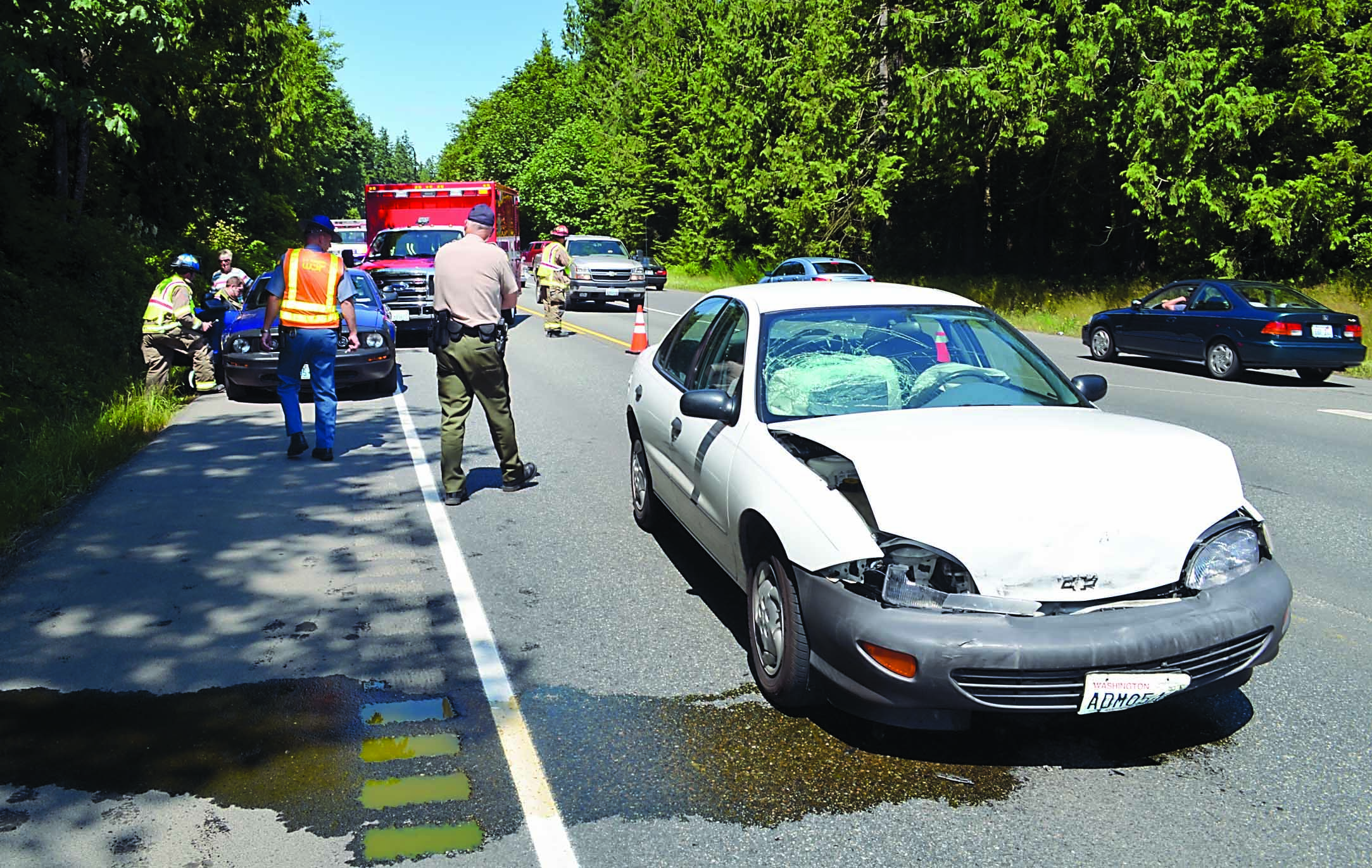 A wreck on U.S. Highway 101 at Schoolhouse Point Road briefly blocks traffic Monday. Clallam County Fire District No. 3