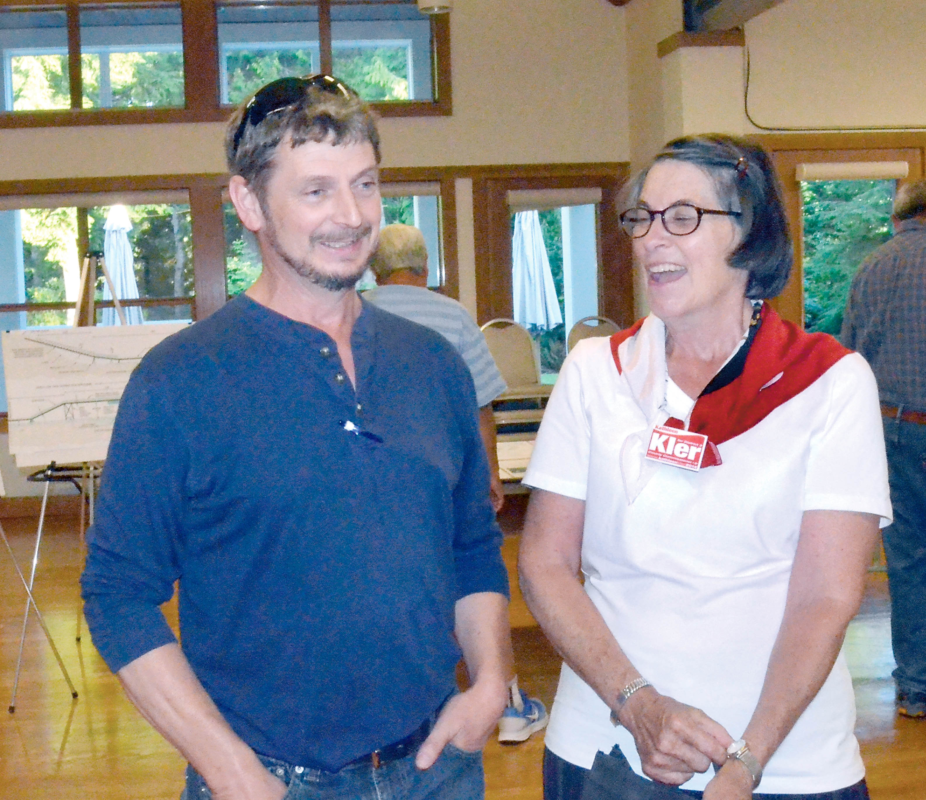 Commissioner candidates Dan Toepper and Kathleen Cler chat at a community development open house on Monday