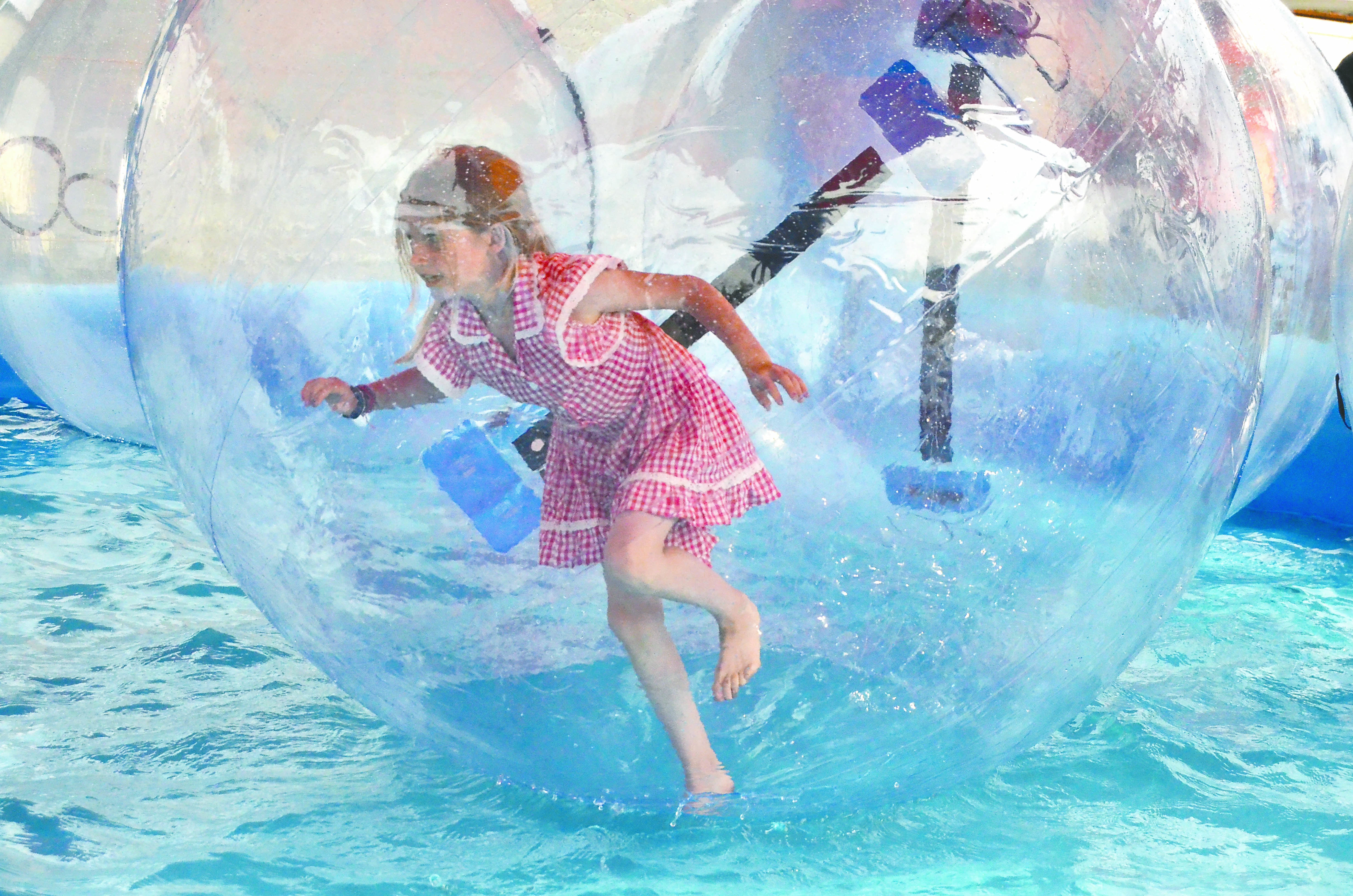 Mariel Holloway Price of Port Townsend walks in a Water Ball in a new attraction at the Jefferson County Fair.  -- Photo by Charlie Bermant/Peninsula Daily News