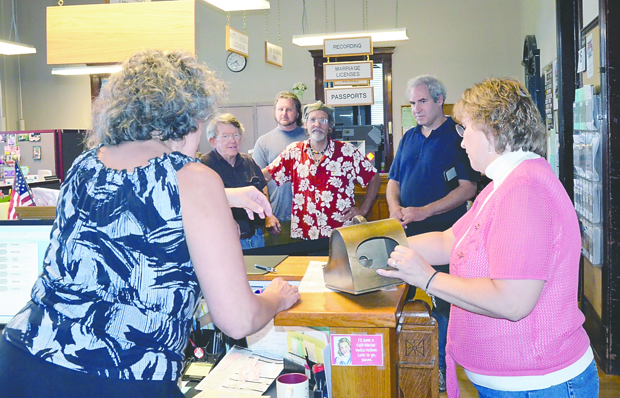 Jefferson County Elections personnel Karen Cartmel and Betty Johnson (in front) draw ballot position lots on Friday afternoon as candidates (from left) John Wood
