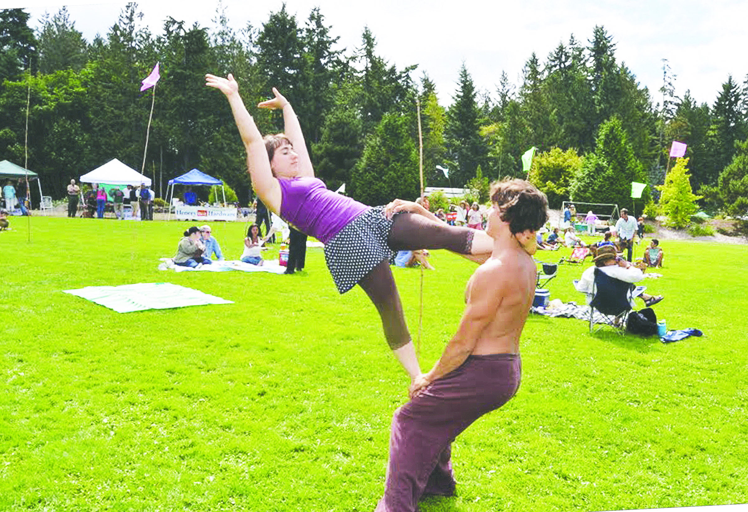 Sadie LaDonna uses Shawn Kellogg as a stairway for an acrobatic flip during the first All-County Picnic on Sunday in Chimacum.  -- Photo by Charlie Bermant/Peninsula Daily News