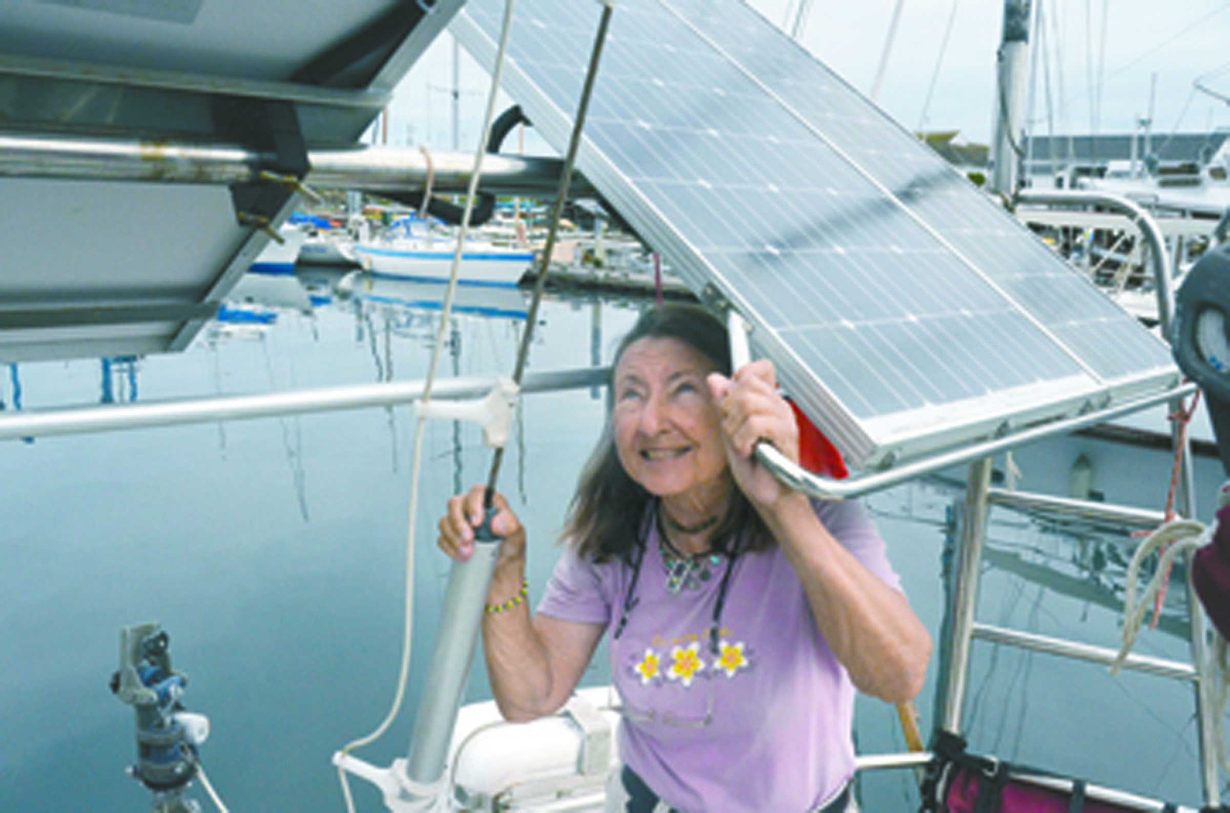 Jeanne Socrates inspects the solar panels on her sailboat