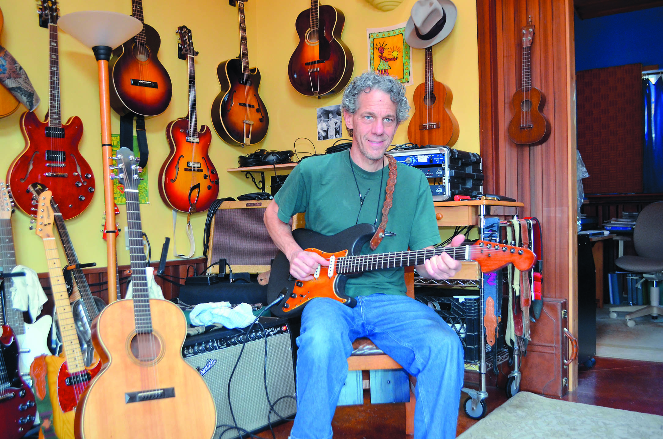 George Rezendes plays the 1966 Fender Stratocaster his mother gave him when he was 12 years old. At left is the first guitar he ever made