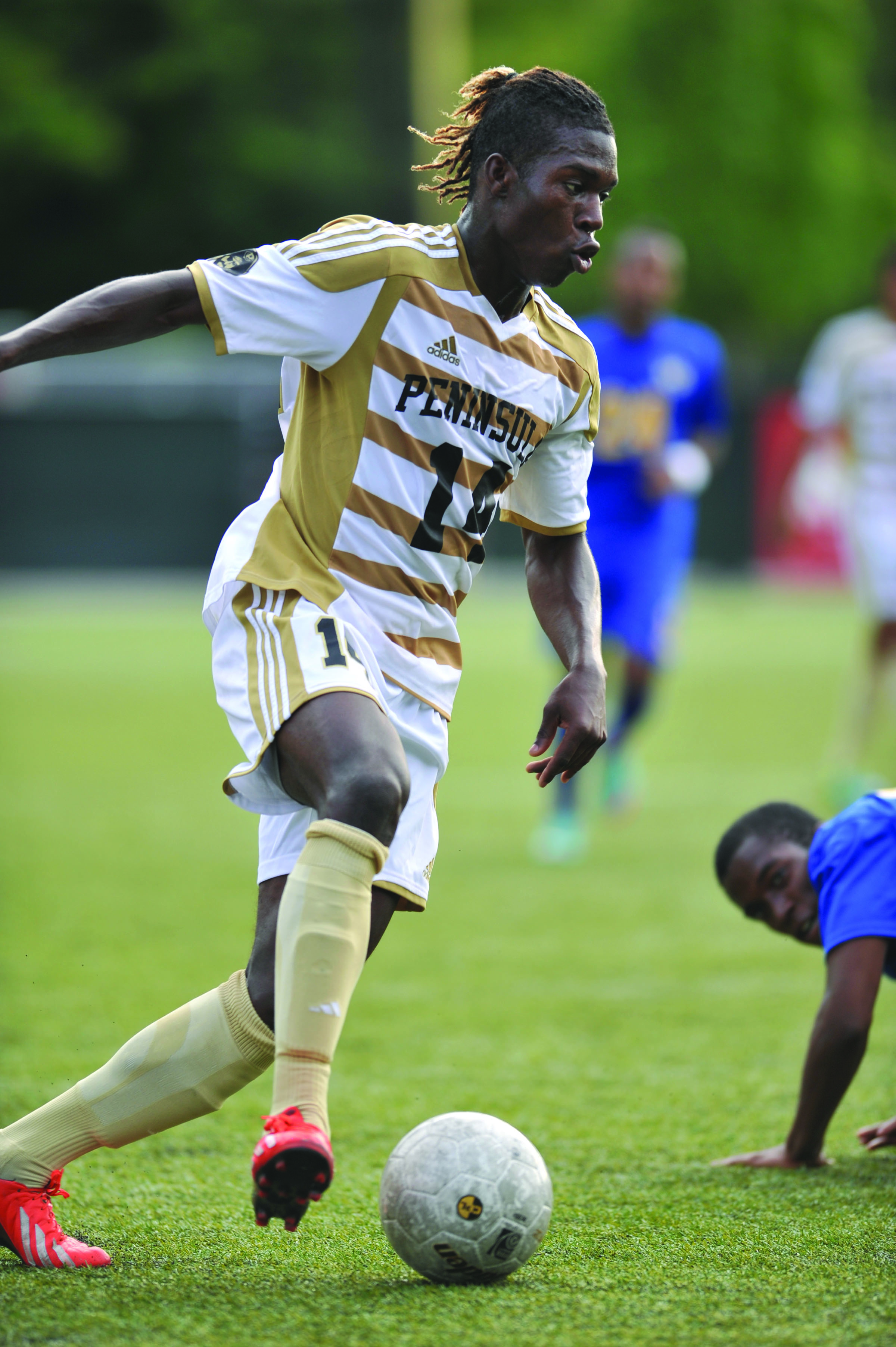 Peninsula College's Ashkanov Apollon dribbles up the pitch during a friendly match against Edmonds. Apollon