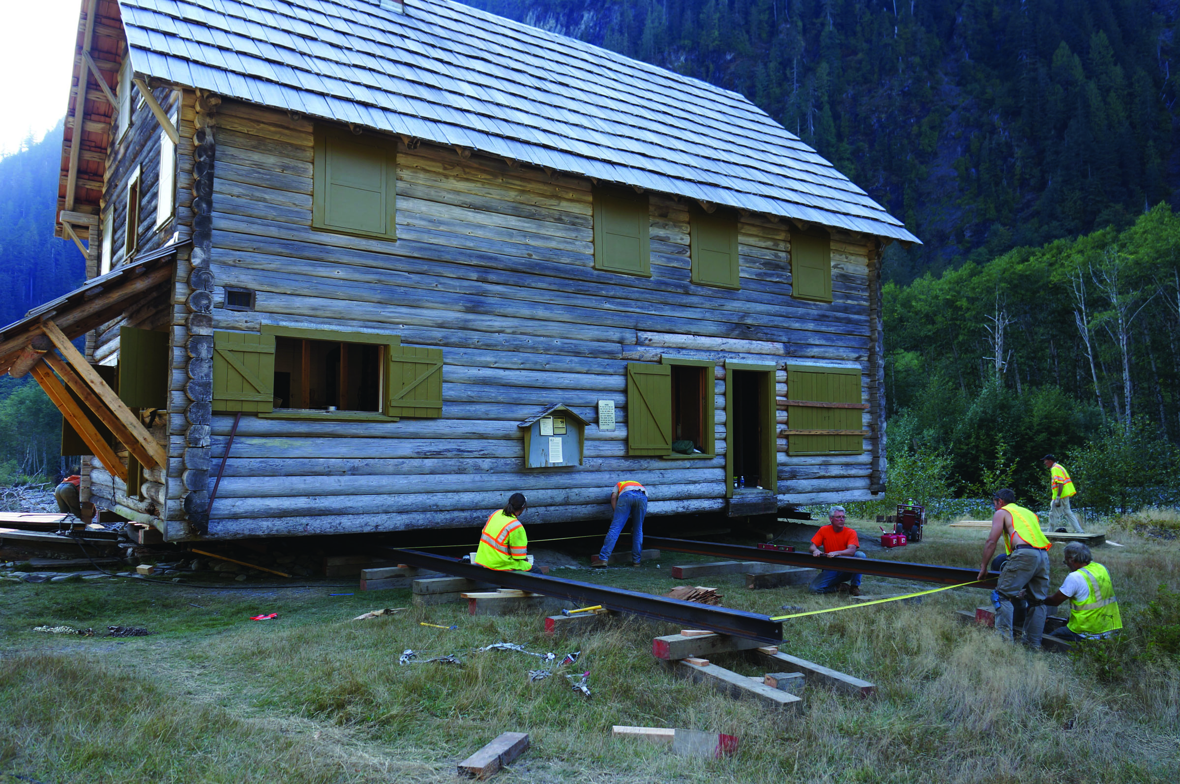 Workers on Sunday ready the steel beams used to move the Enchanted Valley chalet in Olympic National Park. National Park Service