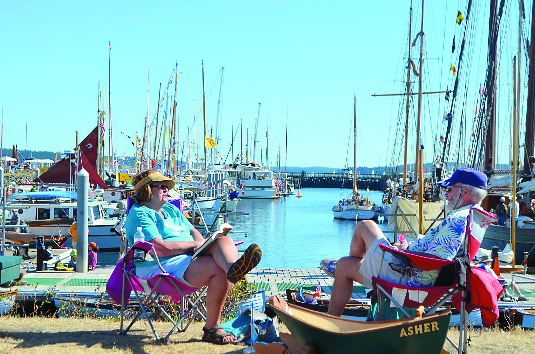 Marilyn and Mike Carosella of Spokane find a prime seat for watching boats come into Port Hudson at the Wooden Boat Festival in Port Townsend. Charlie Bermant/Peninsula Daily News