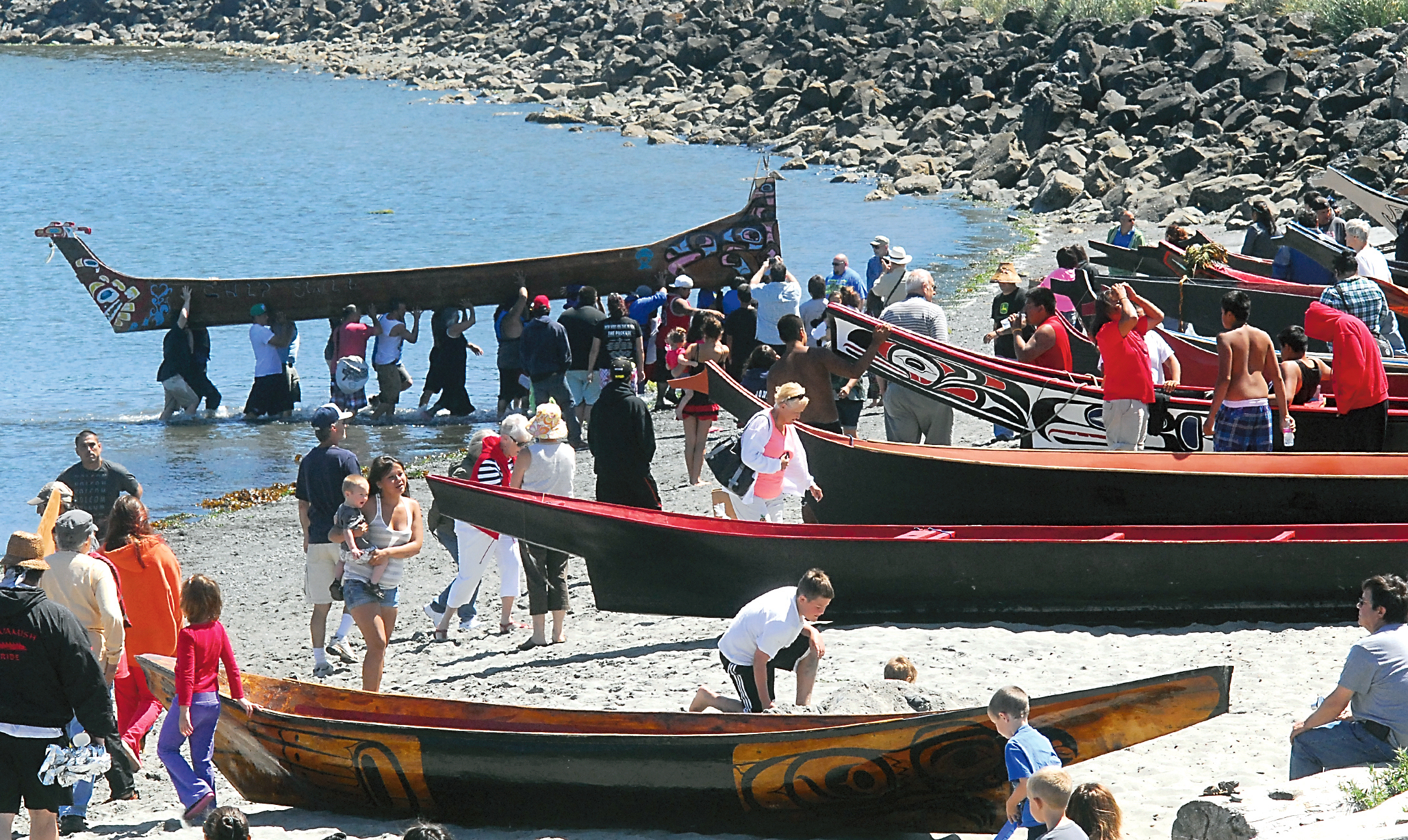 Canoes line Hollywood Beach in Port Angeles as participants in the Paddle to Quinault 2013 arrive at the traditional territory of the Lower Elwha Klallam tribe. — Keith Thorpe/Peninsula Daily News