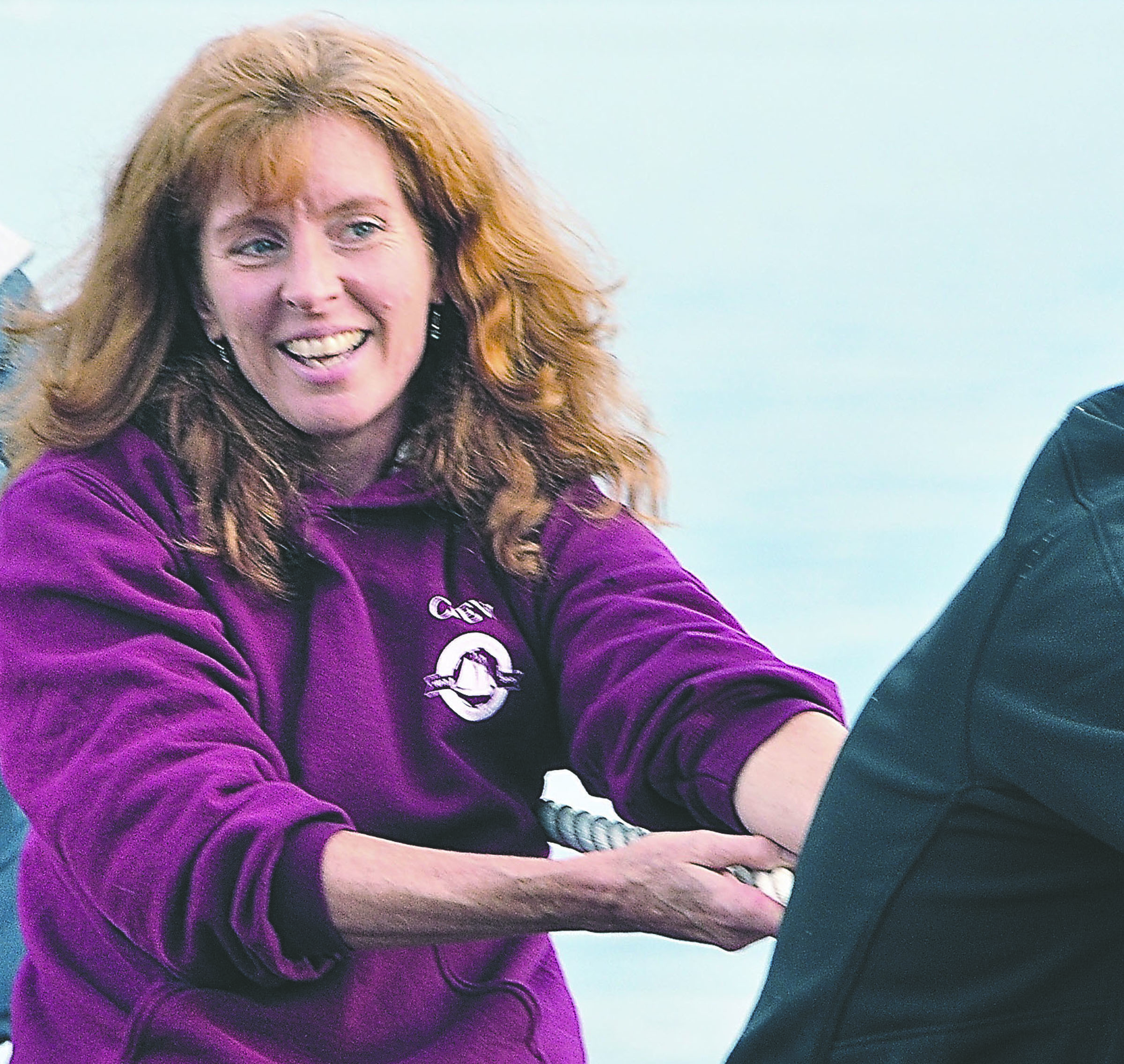 Sound Experience Executive Director Catherine Collins helps to raise the sails on a recent voyage of the schooner Adventuress.  -- Photo by Elizabeth Becker