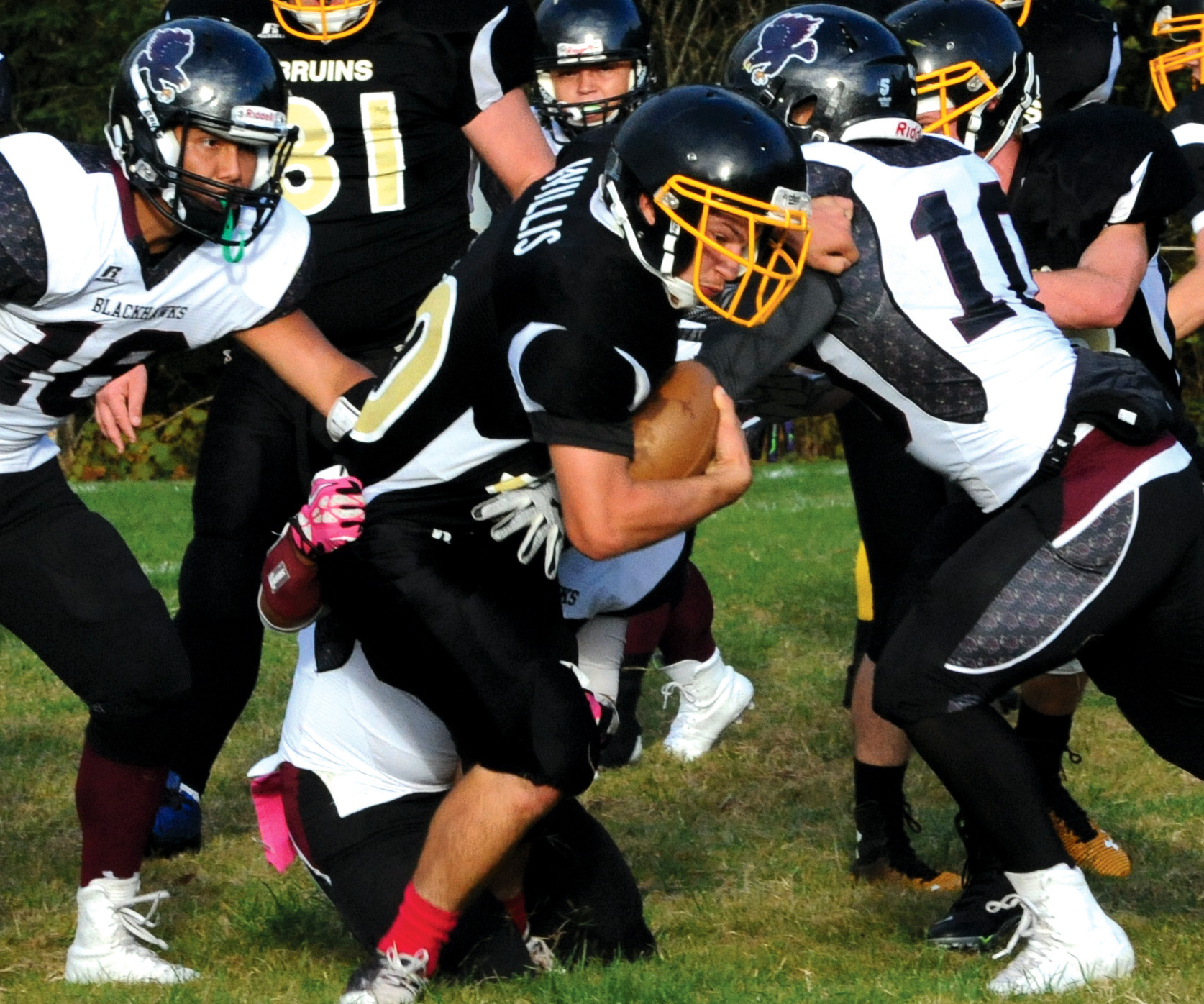 Clallam Bay's Clayton Willis fights for yardage against Lummi's John Ballew